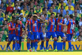 NORWICH, ENGLAND - AUGUST 08: Damien Delaney (3rd R) of Crystal Palace celebrates scoring his team's second goal with his team mates during the Barclays Premier League match between Norwich City and Crystal Palace at Carrow Road on August 8, 2015 in Norwi