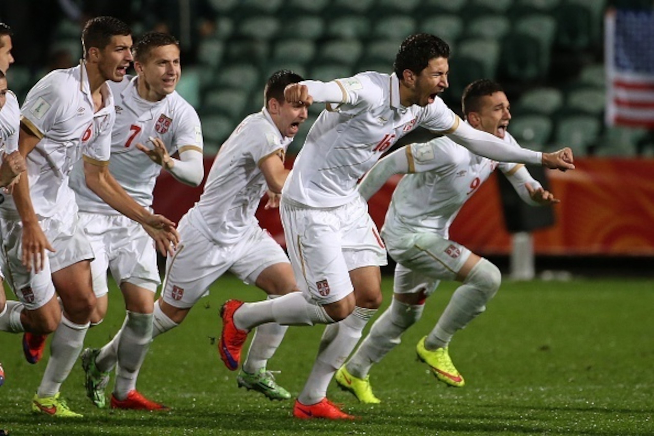 Marko Grujic of Serbia (2nd R) leads teammates as they celebrate their victory during a penalty shootout during the FIFA U20 World Cup quarter-final match between the USA and Serbia in Auckland on June 14, 2015.     AFP PHOTO / Fiona GOODALL        (Photo