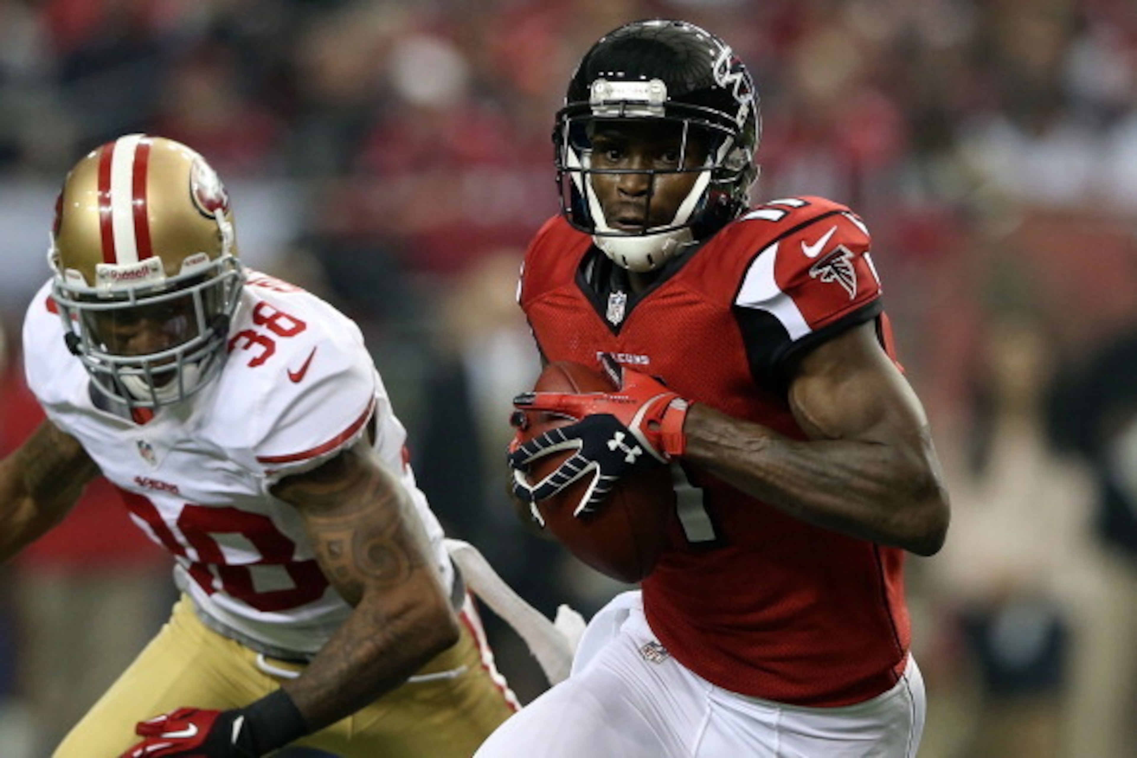 ATLANTA, GA - JANUARY 20:  Wide receiver Julio Jones #11 of the Atlanta Falcons runs after a catch in front of free safety Dashon Goldson #38 of the San Francisco 49ers in the first half in the NFC Championship game at the Georgia Dome on January 20, 2013