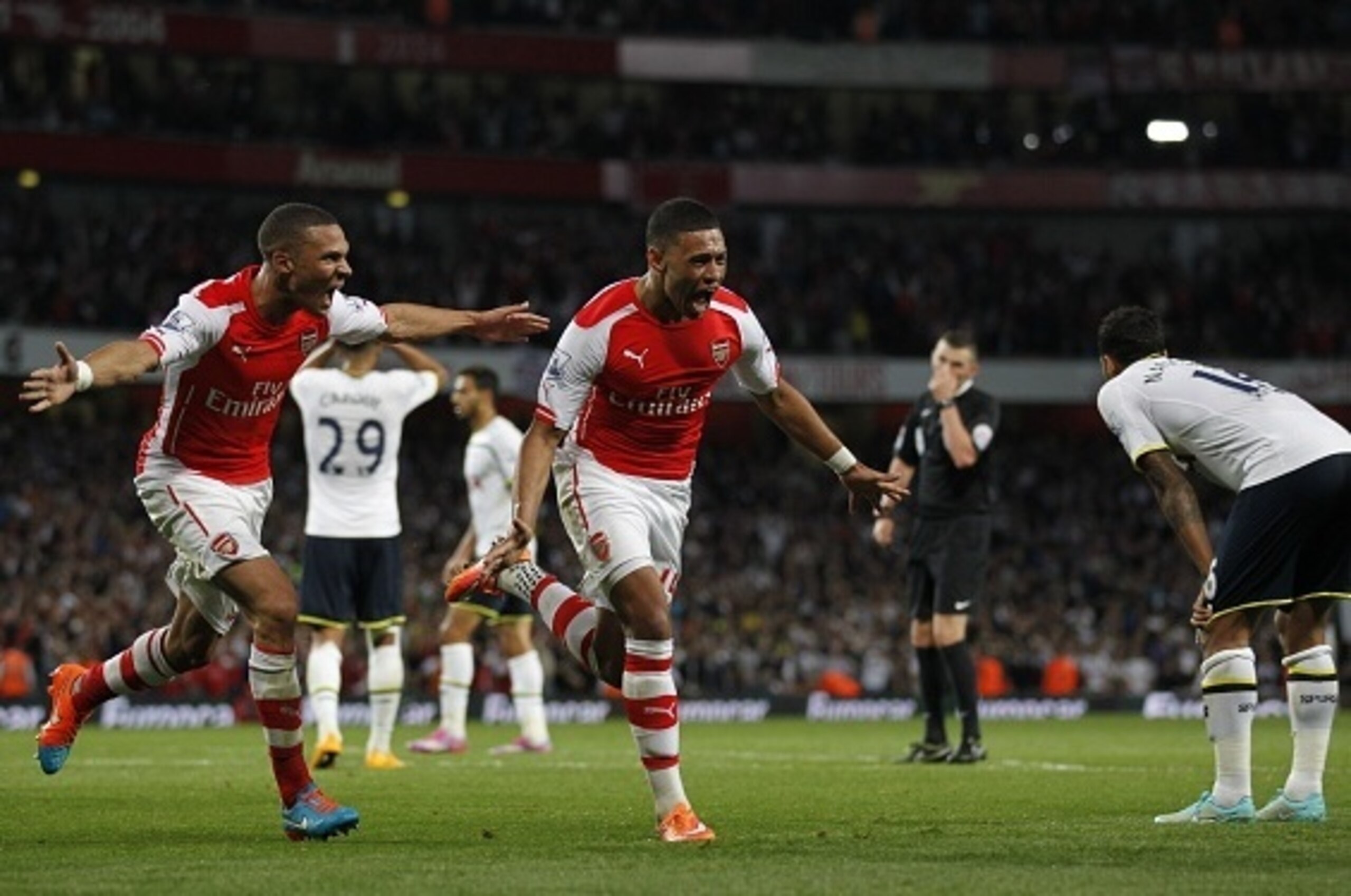 Arsenals English striker Alex Oxlade-Chamberlain (2-L) celebrates scoring a goal during the English Premier League football match between Arsenal and Tottenham Hotspur at The Emirates Stadium in London on on September 27, 2014. AFP PHOTO/IAN KINGTON - RE Arsenals English striker Alex Oxlade-Chamberlain (2-L) celebrates scoring a goal during the English Premier League football match between Arsenal and Tottenham Hotspur at The Emirates Stadium in London on on September 27, 2014. AFP PHOTO/IAN KINGTON - RE