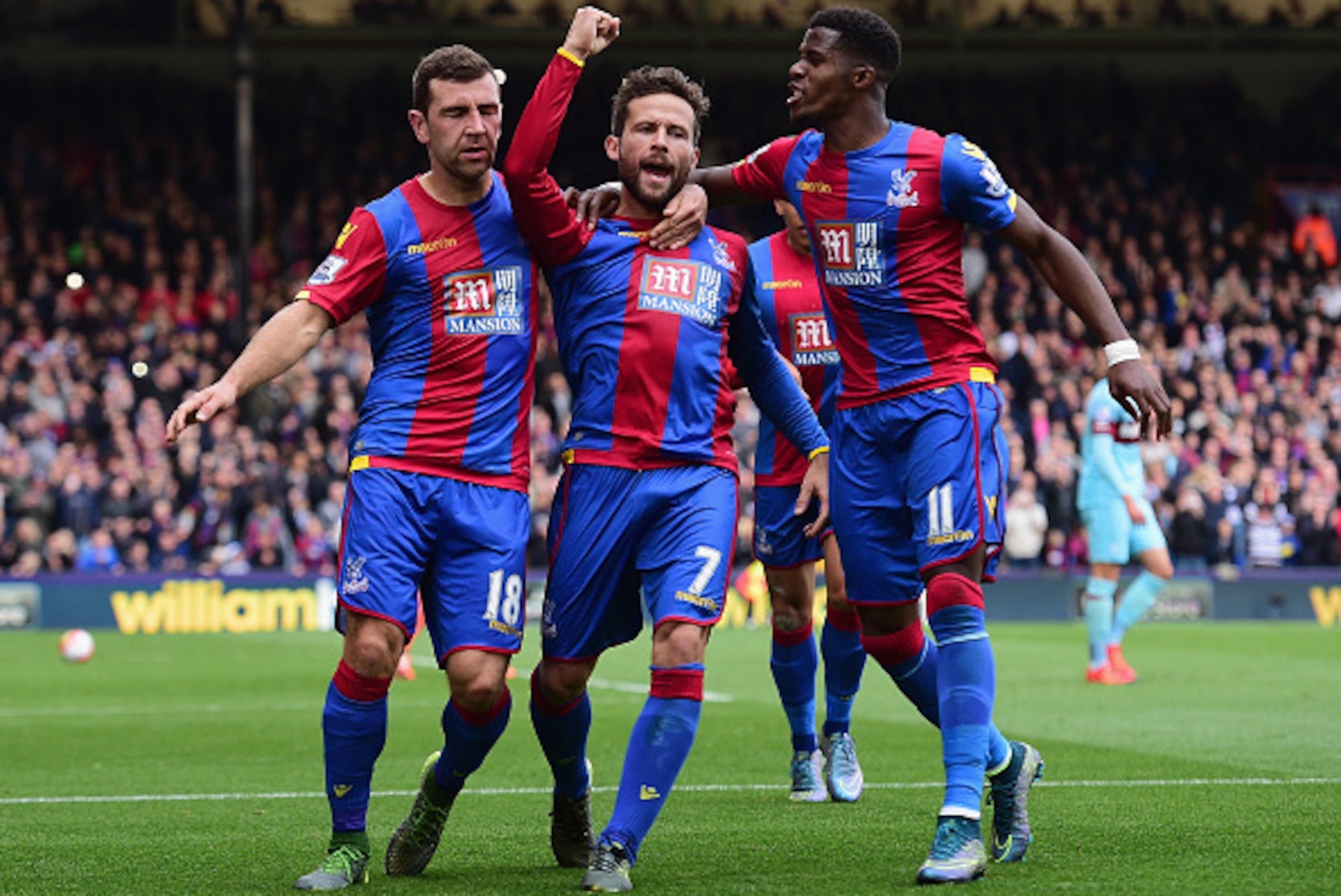 LONDON, ENGLAND - OCTOBER 17:  Yohan Cabaye (C) of Crystal Palace celebrates scoring his team's first goal with his team mates James McArthur (L) and Wilfried Zaha (R) during the Barclays Premier League match between Crystal Palace and West Ham United at 