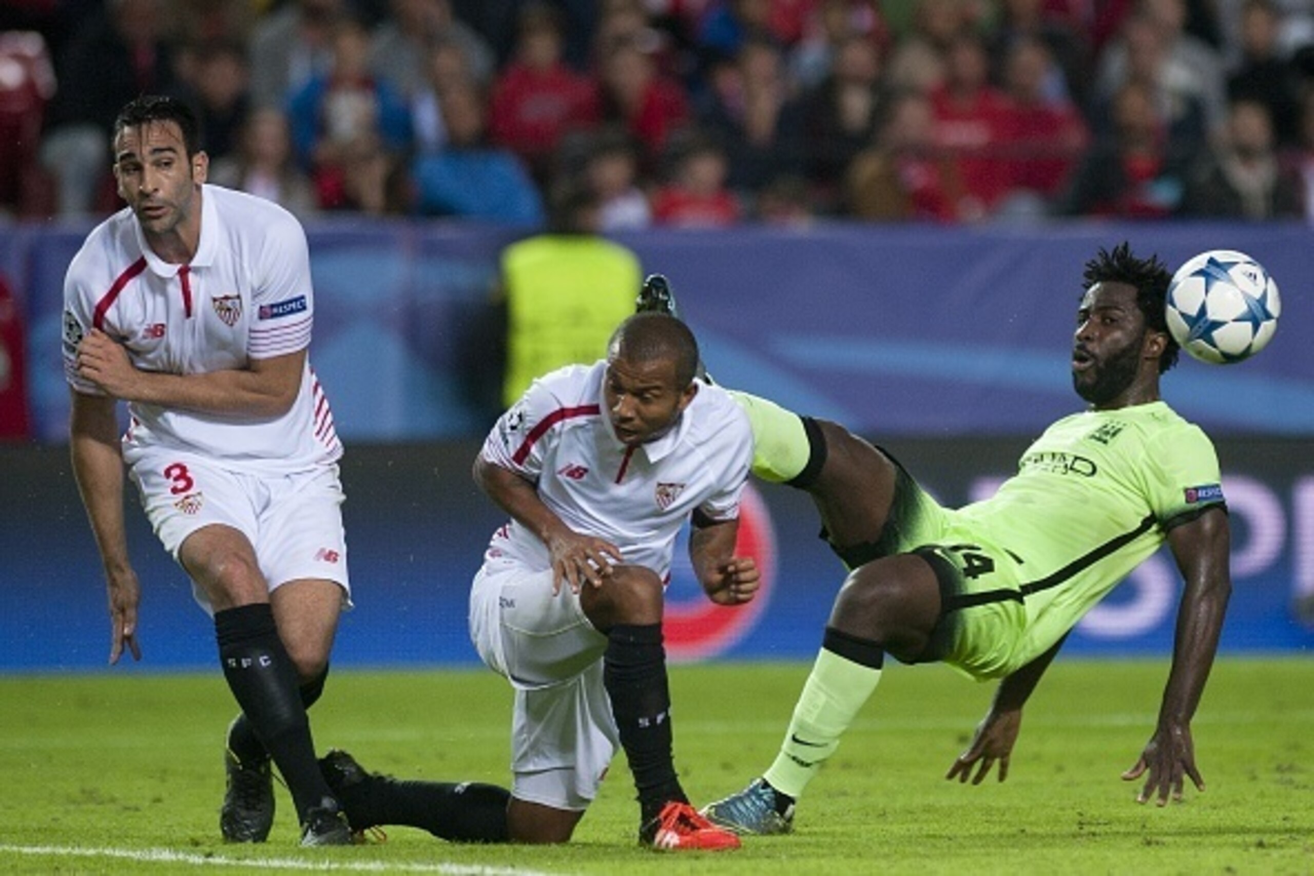 Sevilla's French defender Adil Rami (L) and Brazilian defender Mariano Ferreira (C) vie with Manchester City's Ivorian forward Wilfried Bony during the UEFA Champions League football match Sevilla FC vs Manchester City at the Ramon Sanchez Pizjuan stadium
