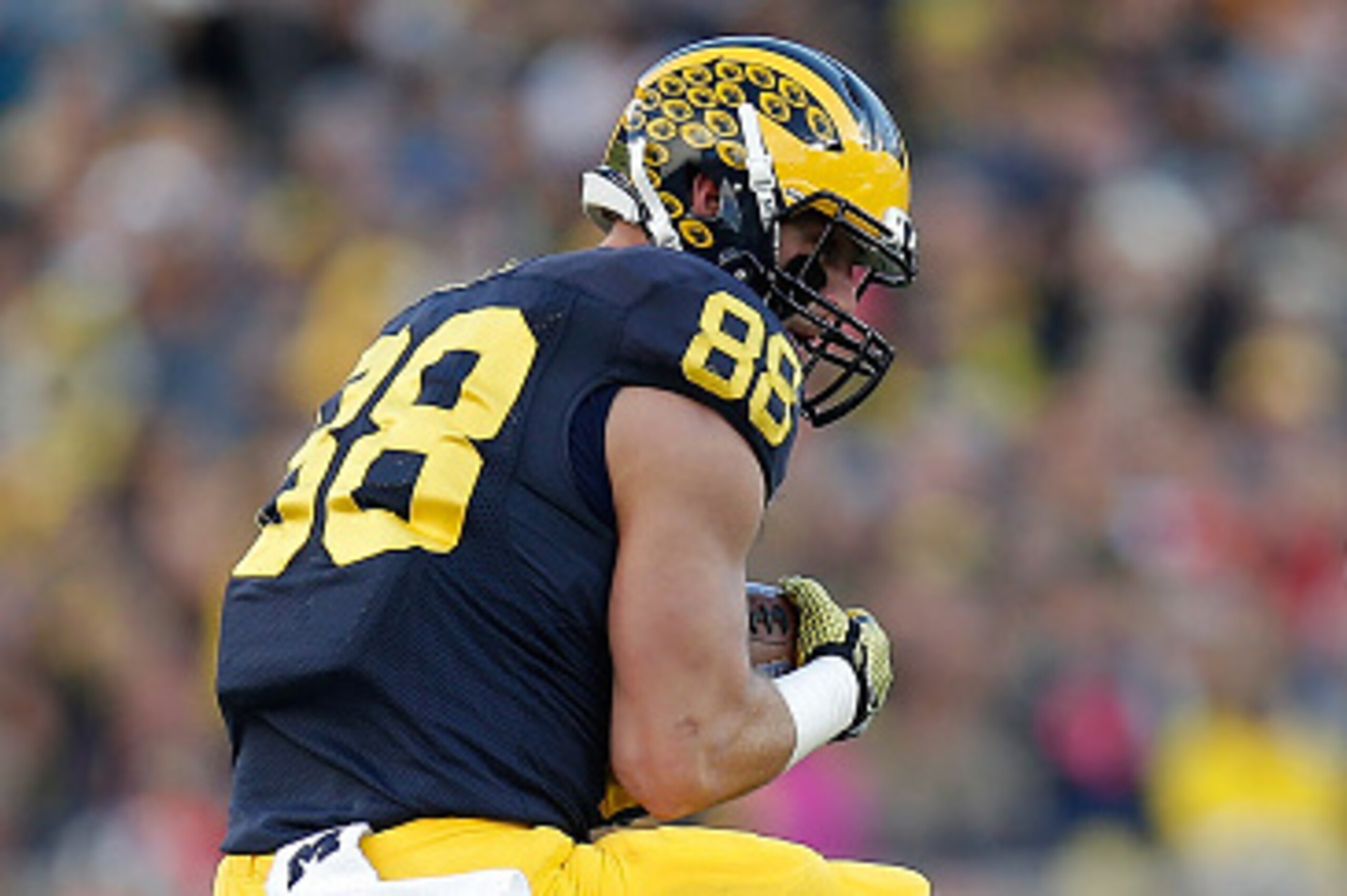 ANN ARBOR, MI - NOVEMBER 07:  Jake Butt #88 of the Michigan Wolverines comes down with a first quarter catch while being tackled by Saquan Hampton #9 of the Rutgers Scarlet Knights on November 7, 2015 at Michigan Stadium in Ann Arbor, Michigan. (Photo by 