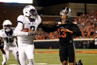 STILLWATER, OK - NOVEMBER 7 :  Quarterback Trevone Boykin #2 of the TCU Horned Frogs pushes safety Jordan Sterns #13 of the Oklahoma State Cowboys November 7, 2015 at Boone Pickens Stadium in Stillwater, Oklahoma. The Cowboys defeated the Horned Frogs 49-