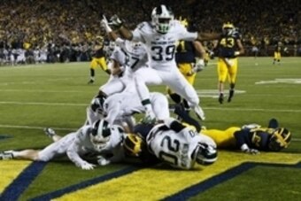 Oct 17, 2015; Ann Arbor, MI, USA; Michigan State Spartans defensive back Jalen Watts-Jackson (20) dives into the end zone for a game winning touchdown as the clock runs out in the fourth quarter against the Michigan Wolverines at Michigan Stadium. Michiga