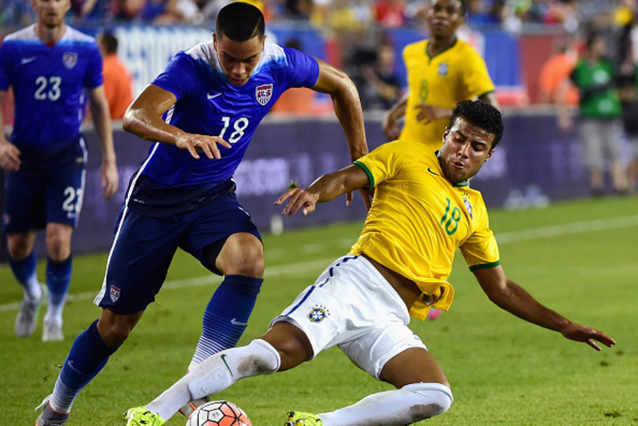 FOXBORO, MA - SEPTEMBER 08:  Bobby Wood #18 of the United States tackles Rafinha #18 of Brazil during an international friendly at Gillette Stadium on September 8, 2015 in Foxboro, Massachusetts.  (Photo by Billie Weiss/Getty Images)