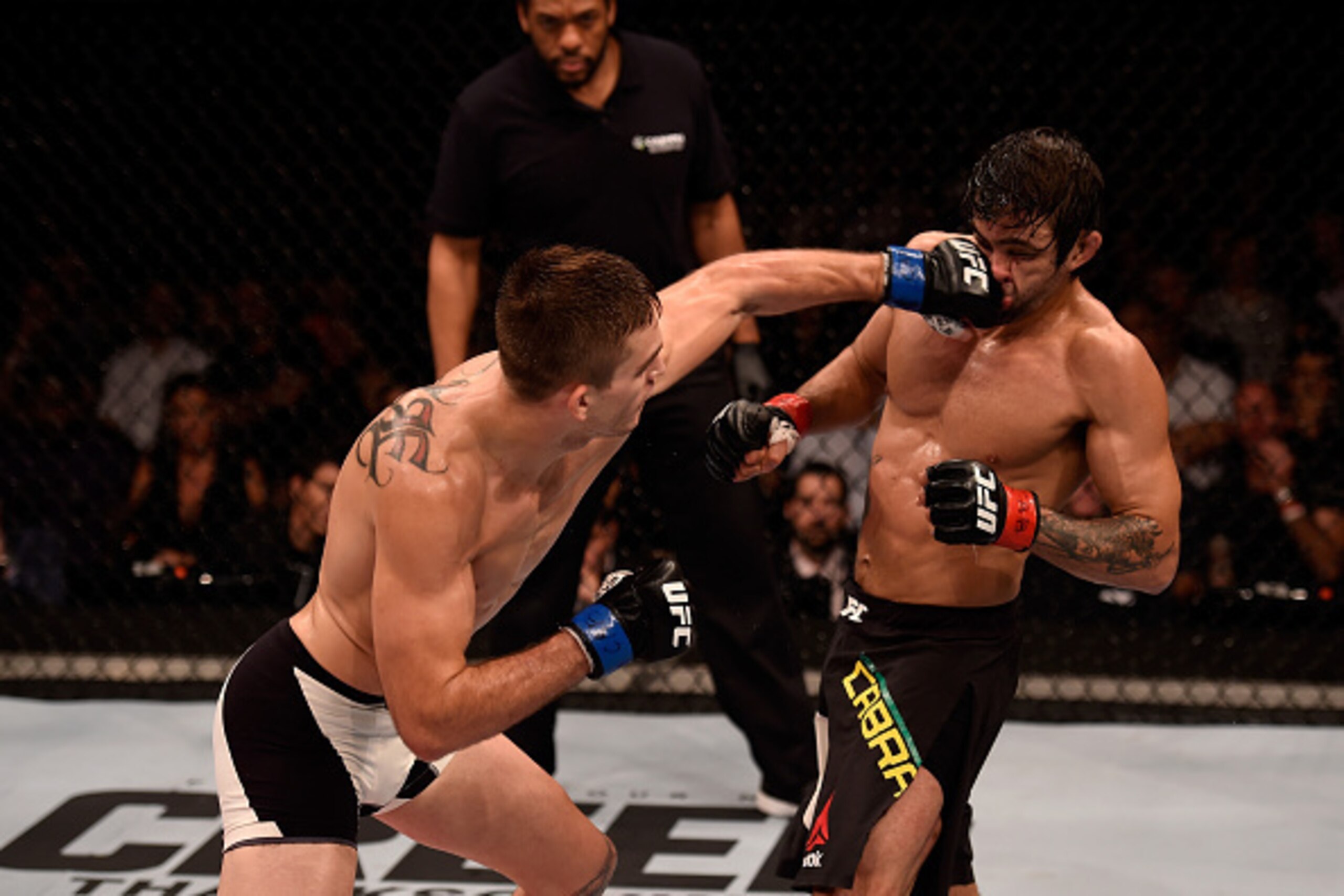SAO PAULO, BRAZIL - NOVEMBER 07:  Johnny Case of the United States punches Yan Cabral of Brazil in their lightweight bout during the UFC Fight Night Belfort v Henderson at Ibirapuera Gymnasium on November 7, 2015 in Sao Paulo, Brazil.  (Photo by Buda Mend