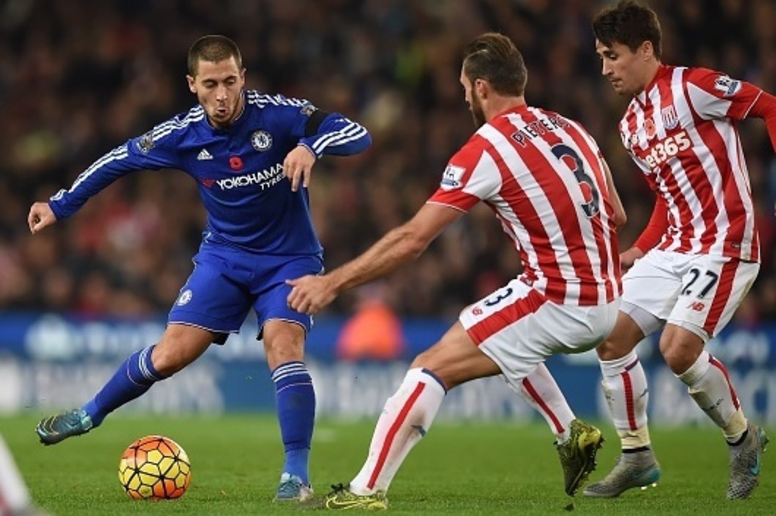 Chelsea's Belgian midfielder Eden Hazard (L) vies with Stoke City's Dutch defender Erik Pieters and Stoke City's Spanish striker Bojan Krkic (R) during the English Premier League football match between Stoke City and Chelsea at the Britannia Stadium in St Chelsea's Belgian midfielder Eden Hazard (L) vies with Stoke City's Dutch defender Erik Pieters and Stoke City's Spanish striker Bojan Krkic (R) during the English Premier League football match between Stoke City and Chelsea at the Britannia Stadium in St