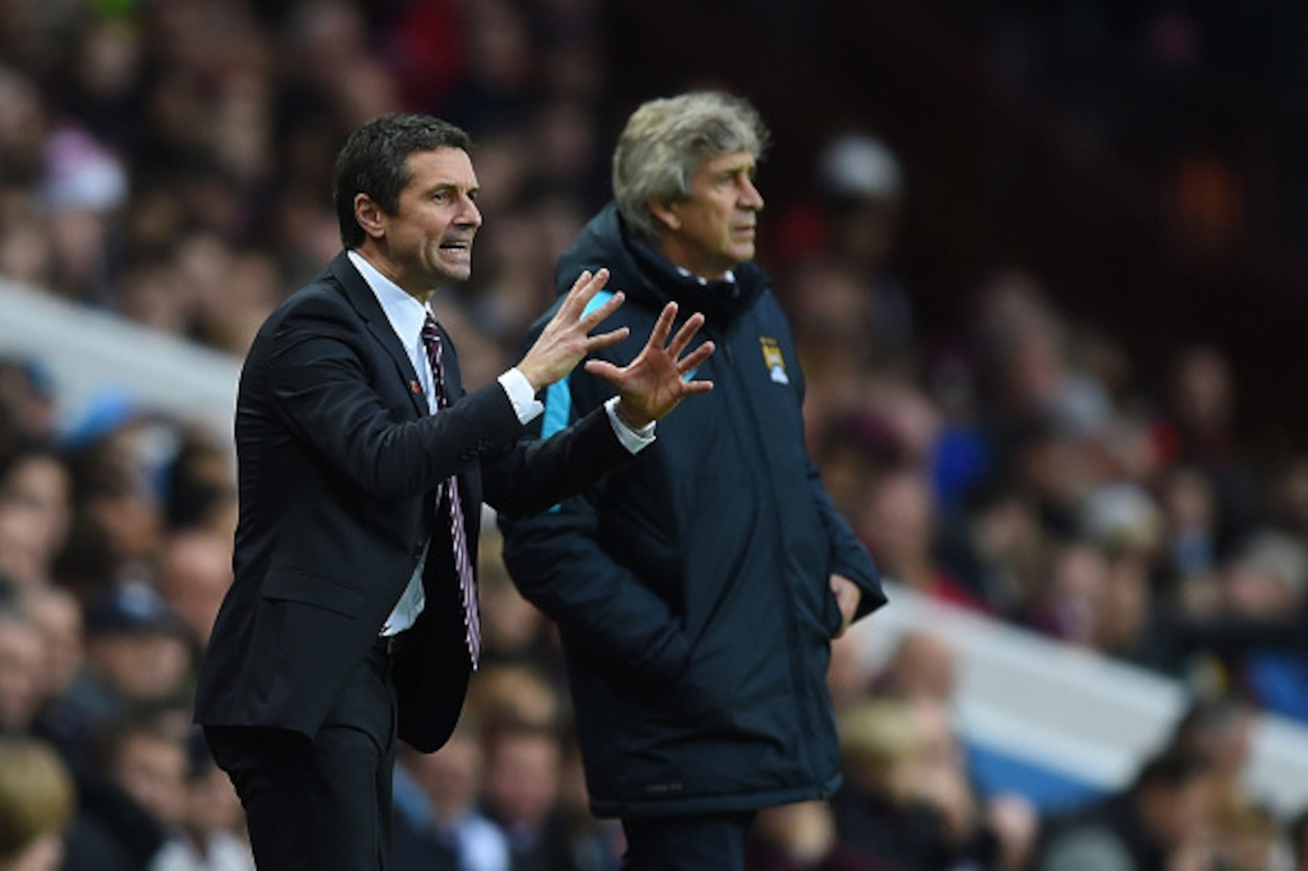 BIRMINGHAM, ENGLAND - NOVEMBER 08:  (L-R) Remi Garde, Manager of Aston Villa directs his players as Manuel Pellegrini the manager of Manchester City looks on during the Barclays Premier League match between Aston Villa and Manchester City at Villa Park on