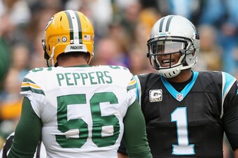 CHARLOTTE, NC - NOVEMBER 08:  Cam Newton #1 of the Carolina Panthers talks to Julius Peppers #56 of the Green Bay Packers in the 1st half during their game at Bank of America Stadium on November 8, 2015 in Charlotte, North Carolina.  (Photo by Streeter Le