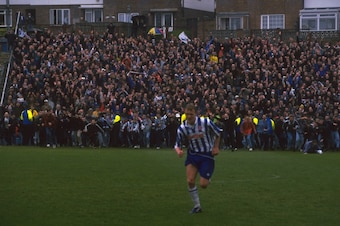 Fans invade the pitch after the last game played at the Goldstone Ground, in April 1997