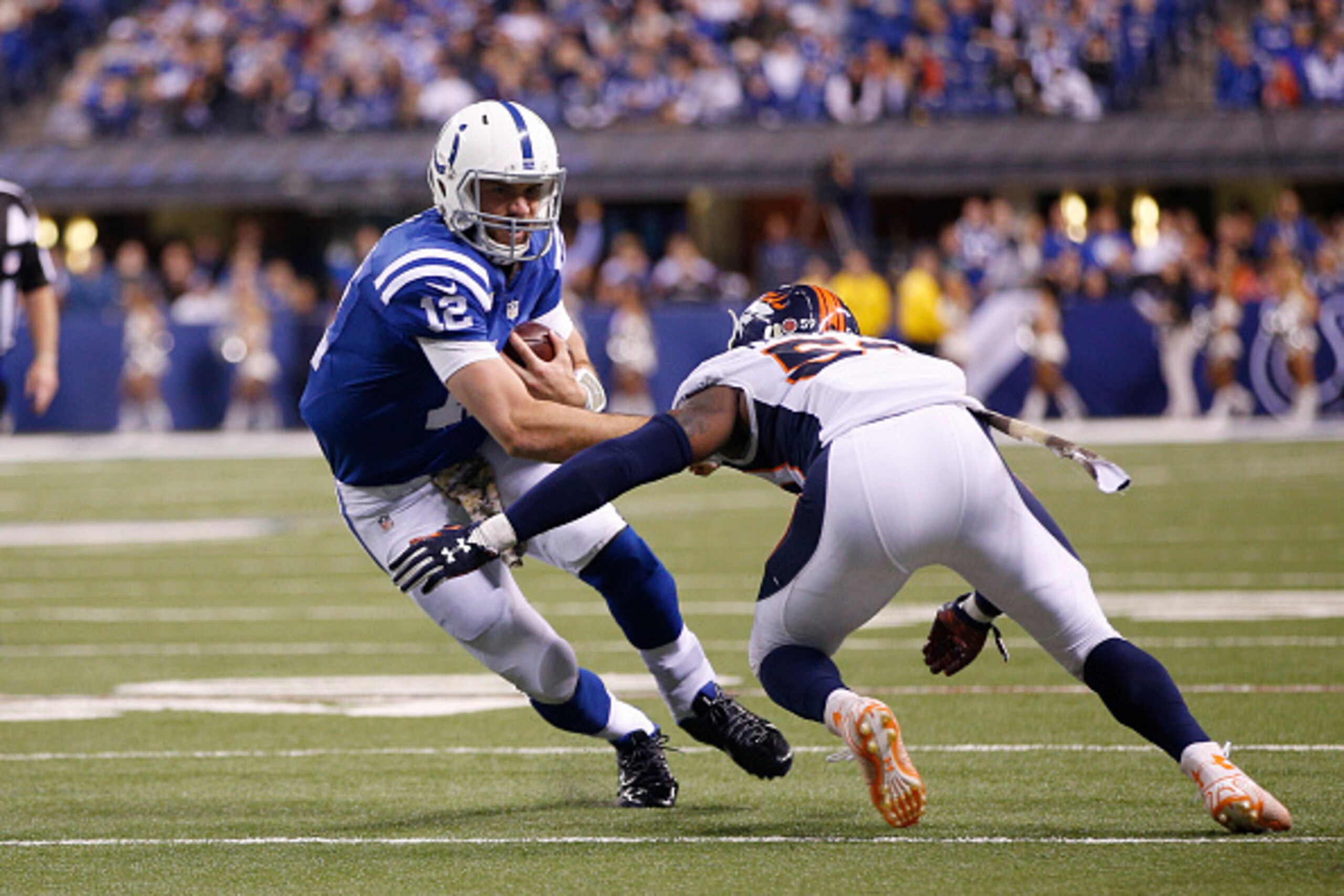 INDIANAPOLIS, IN - NOVEMBER 8: Andrew Luck #12  of the Indianapolis Colts scrambles for yardage against the Denver Broncos in the fourth quarter of the game at Lucas Oil Stadium on November 8, 2015 in Indianapolis, Indiana. (Photo by Joe Robbins/Getty Ima