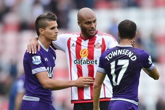SUNDERLAND, ENGLAND - SEPTEMBER 13 : Younes Kabul of Sunderland congratulates ex team mate, Erik Lamela and Andros Townsend of Tottenham Hotspur during the Barclays Premier League match between Sunderland AFC and Tottenham Hotspur FC at the Stadium of Lig