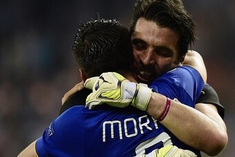 Juventus' Spanish forward Alvaro Morata (L) and  Juventus' goalkeeper and captain Gianluigi Buffon celebrate winning the UEFA Champions League semi-final second leg football match Real Madrid FC vs Juventus at the Santiago Bernabeu stadium in Madrid on Ma