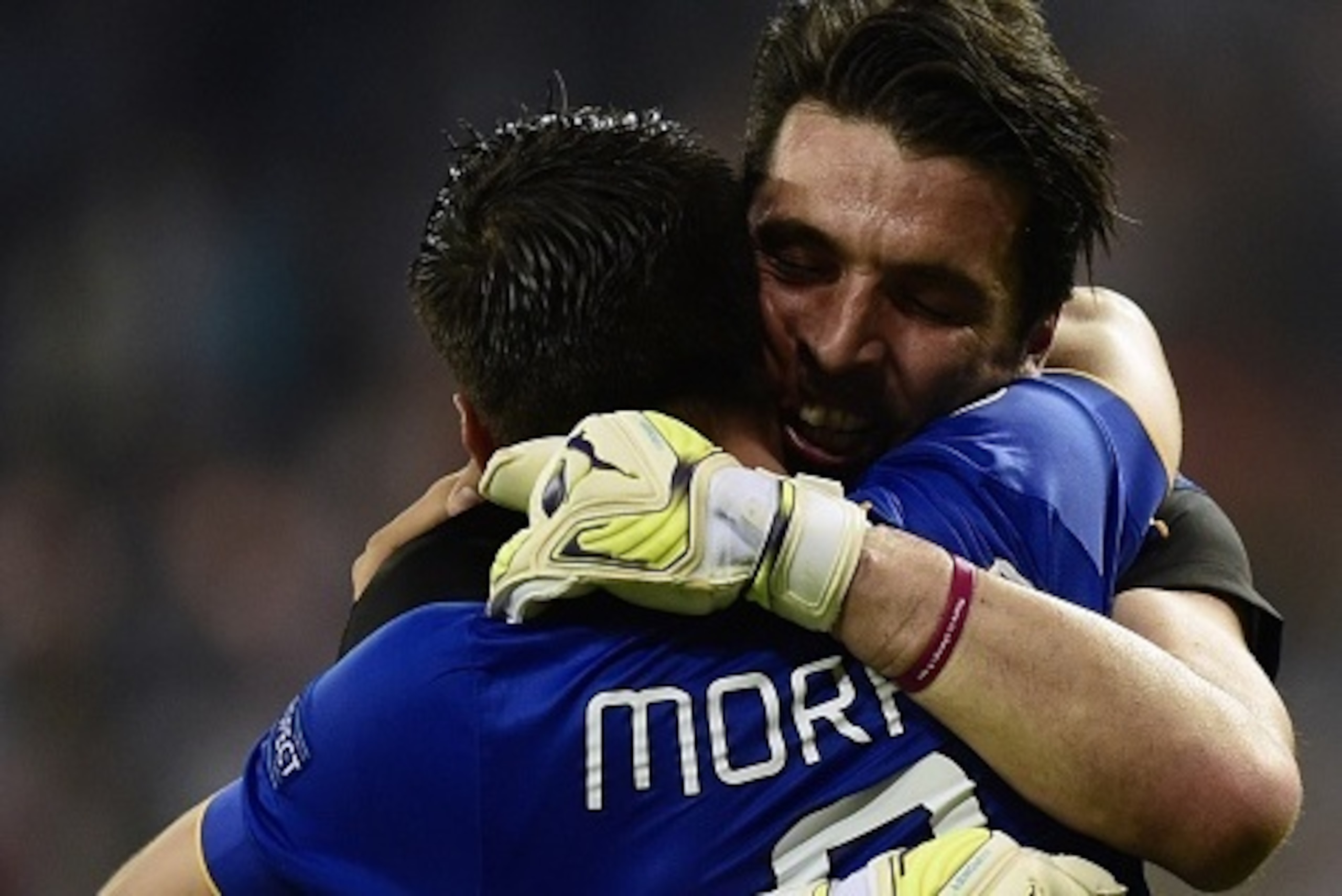 Juventus' Spanish forward Alvaro Morata (L) and  Juventus' goalkeeper and captain Gianluigi Buffon celebrate winning the UEFA Champions League semi-final second leg football match Real Madrid FC vs Juventus at the Santiago Bernabeu stadium in Madrid on Ma