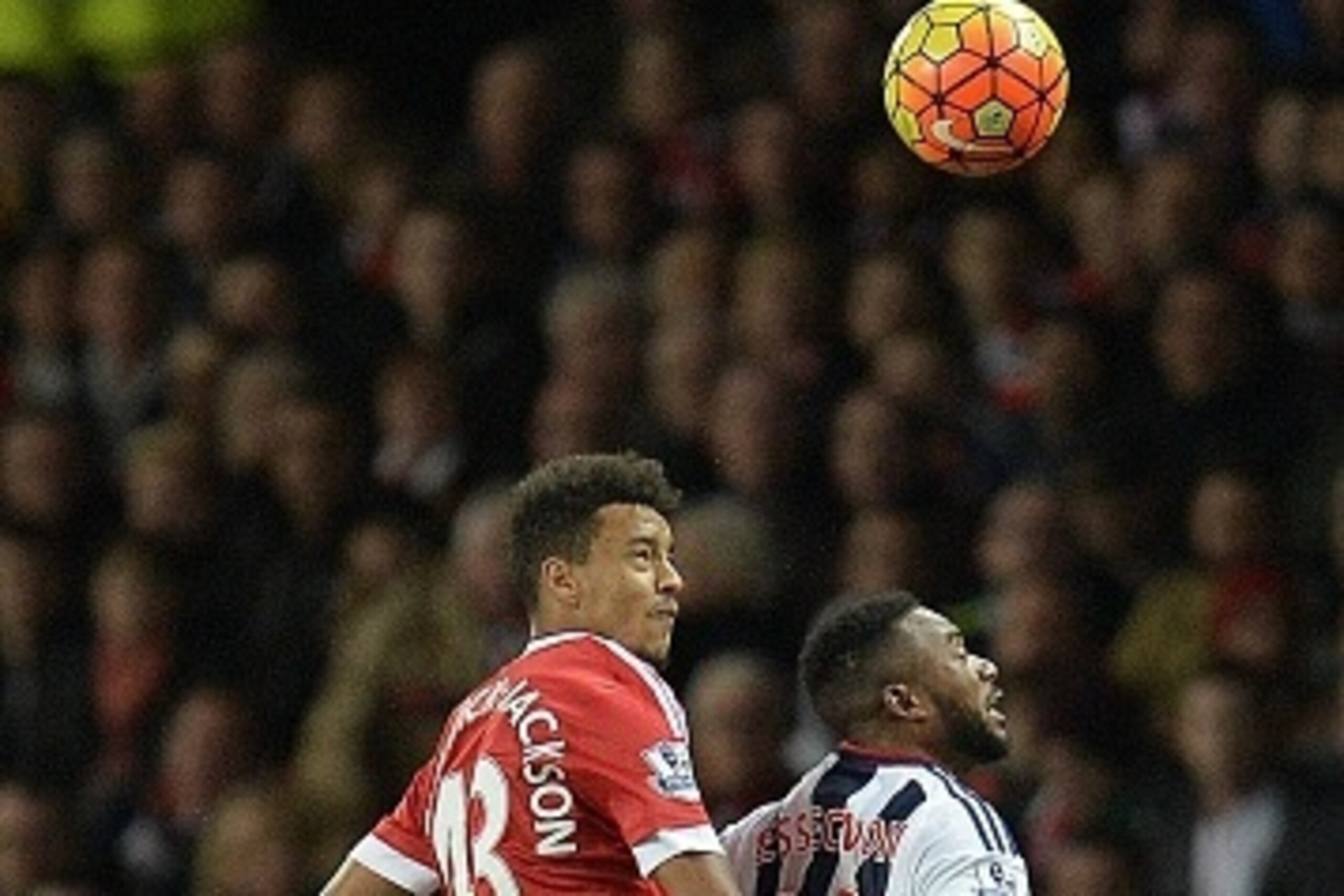 Manchester United's English defender Cameron Borthwick-Jackson (L) vies in the air with West Bromwich Albion's Beninese midfielder Stephane Sessegnon during the English Premier League football match between Manchester United and West Bromwich Albion at Ol