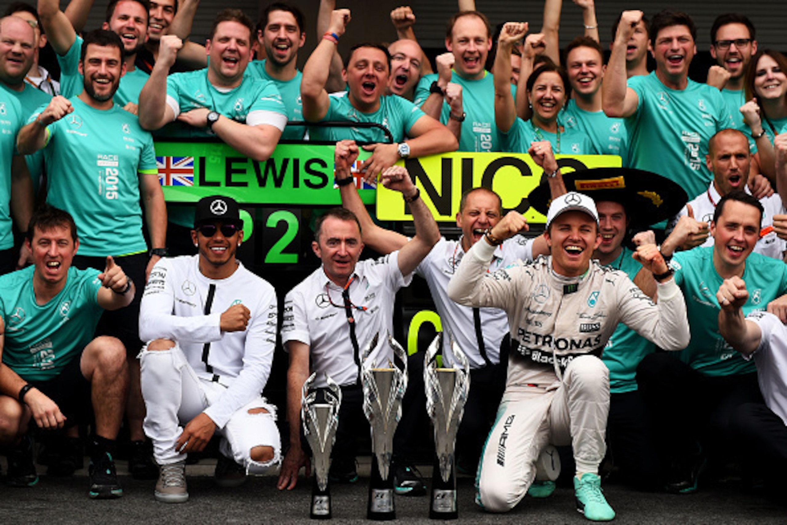 MEXICO CITY, MEXICO - NOVEMBER 01:  Nico Rosberg of Germany and Mercedes GP celebrates with the team, including Lewis Hamilton of Great Britain and Mercedes GP, following his victory in the Formula One Grand Prix of Mexico at Autodromo Hermanos Rodriguez 