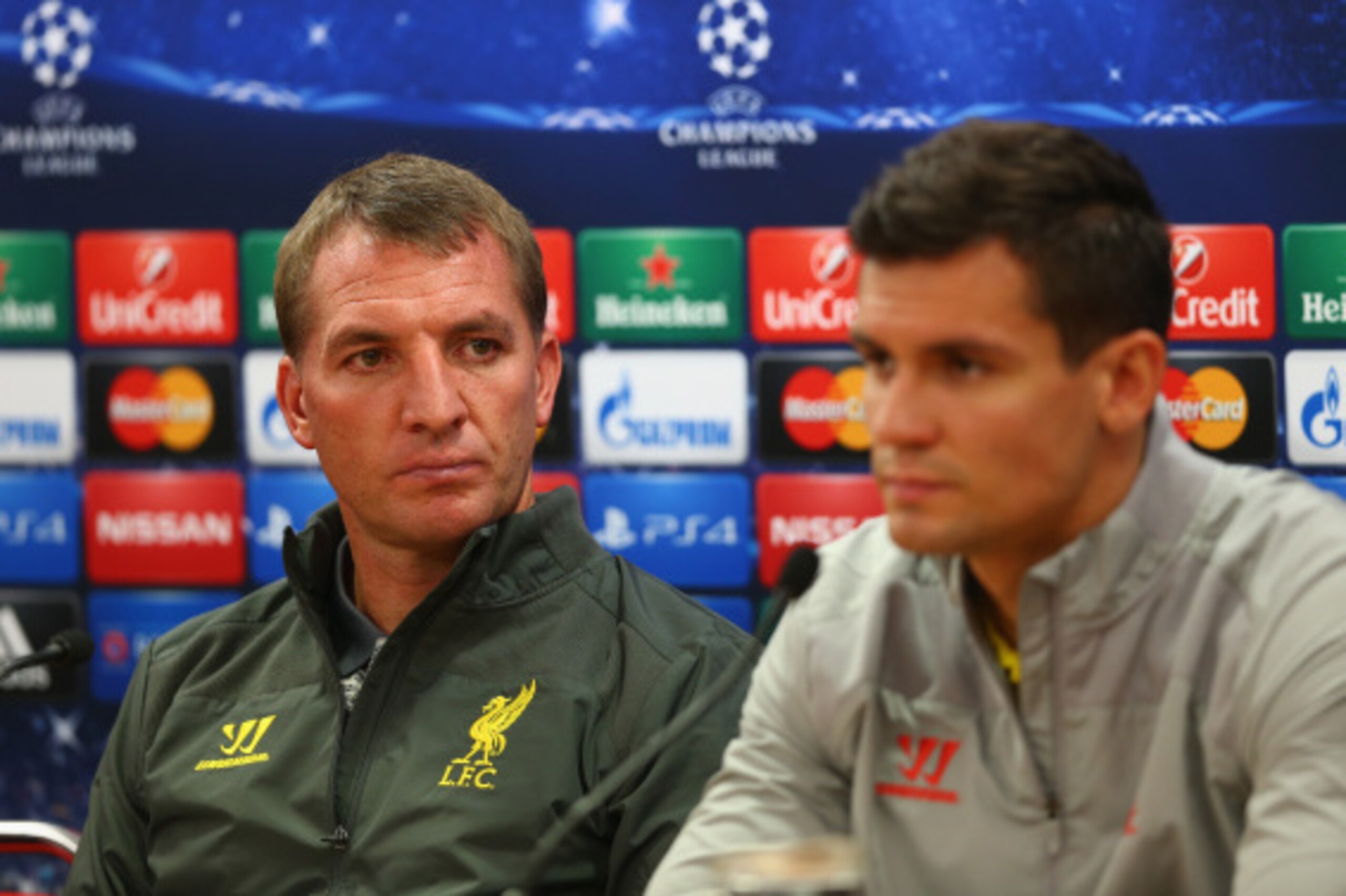 LIVERPOOL, ENGLAND - SEPTEMBER 15:  Liverpool manager Brendan Rodgers deep in thought whilst sitting next to his defender Dejan Lovren during a press conference ahead of their UEFA Champions League group B match against PFC Ludogorets on September 15, 201