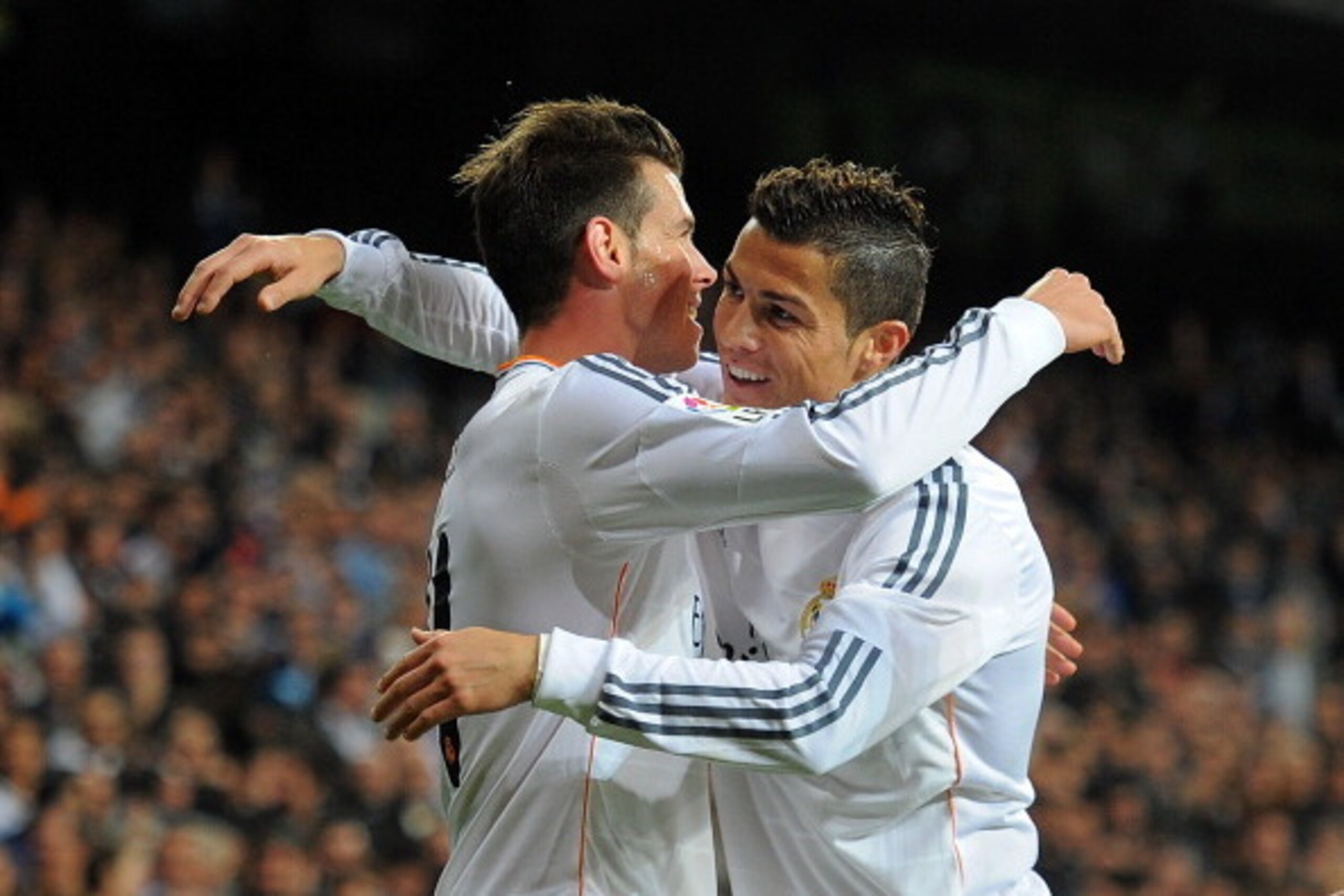 MADRID, SPAIN - OCTOBER 30:  Gareth Bale (L) of Real Madrid CF celebrates with Cristiano Ronaldo after scoring Real's opening goal during the La Liga match between Real Madrid CF and Sevilla FC at the Santiago Bernabeu Stadium on October 30, 2013 in Madri