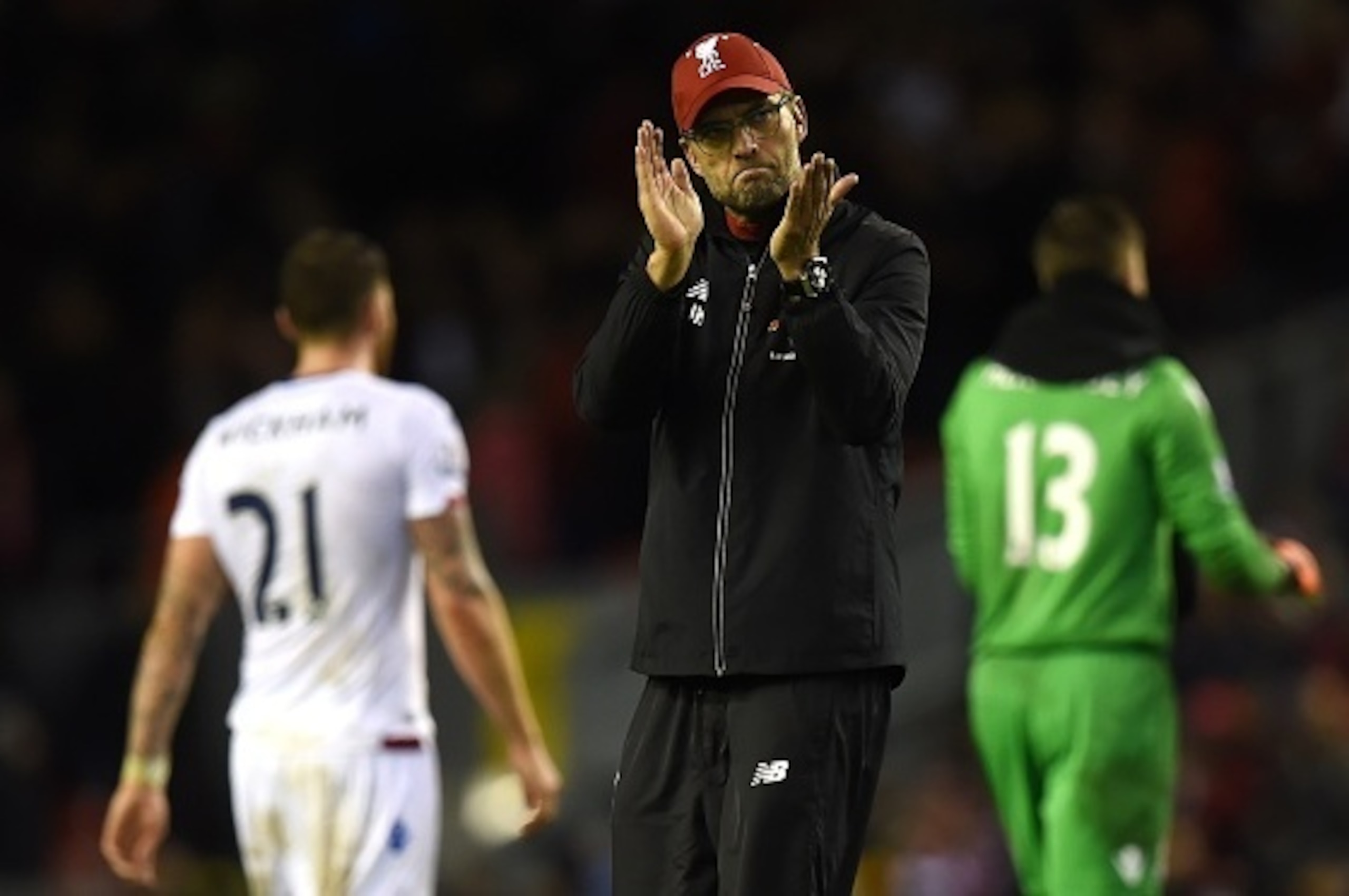 Liverpool's German manager Jurgen Klopp (C) applauds the fans after losing the English Premier League football match between Liverpool and Crystal Palace at the Anfield stadium in Liverpool, north-west England on November 8, 2015.     AFP PHOTO / PAUL ELL