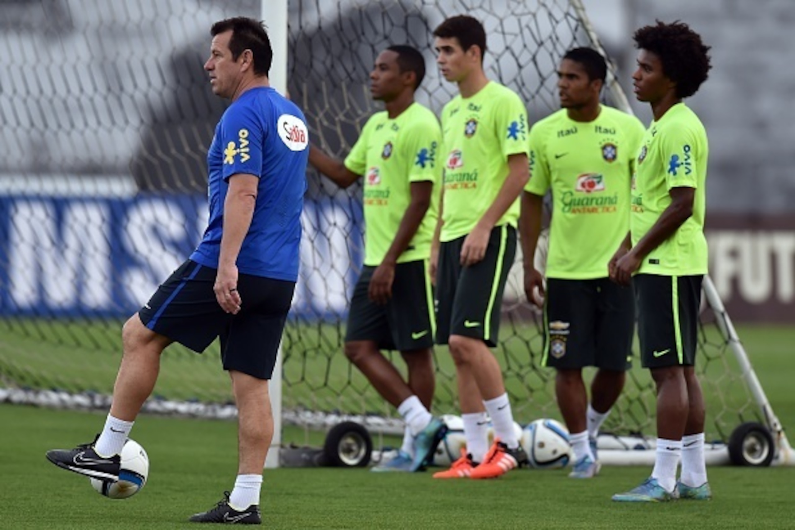 Brazilian team coach Dunga (L) remains next to his players during a training session at the Corinthians training centre in Sao Paulo, Brazil, on November 9, 2015. Brazil will face Argentina on November 12 in a FIFA World Cup Russia 2018 qualifier match. A Brazilian team coach Dunga (L) remains next to his players during a training session at the Corinthians training centre in Sao Paulo, Brazil, on November 9, 2015. Brazil will face Argentina on November 12 in a FIFA World Cup Russia 2018 qualifier match. A