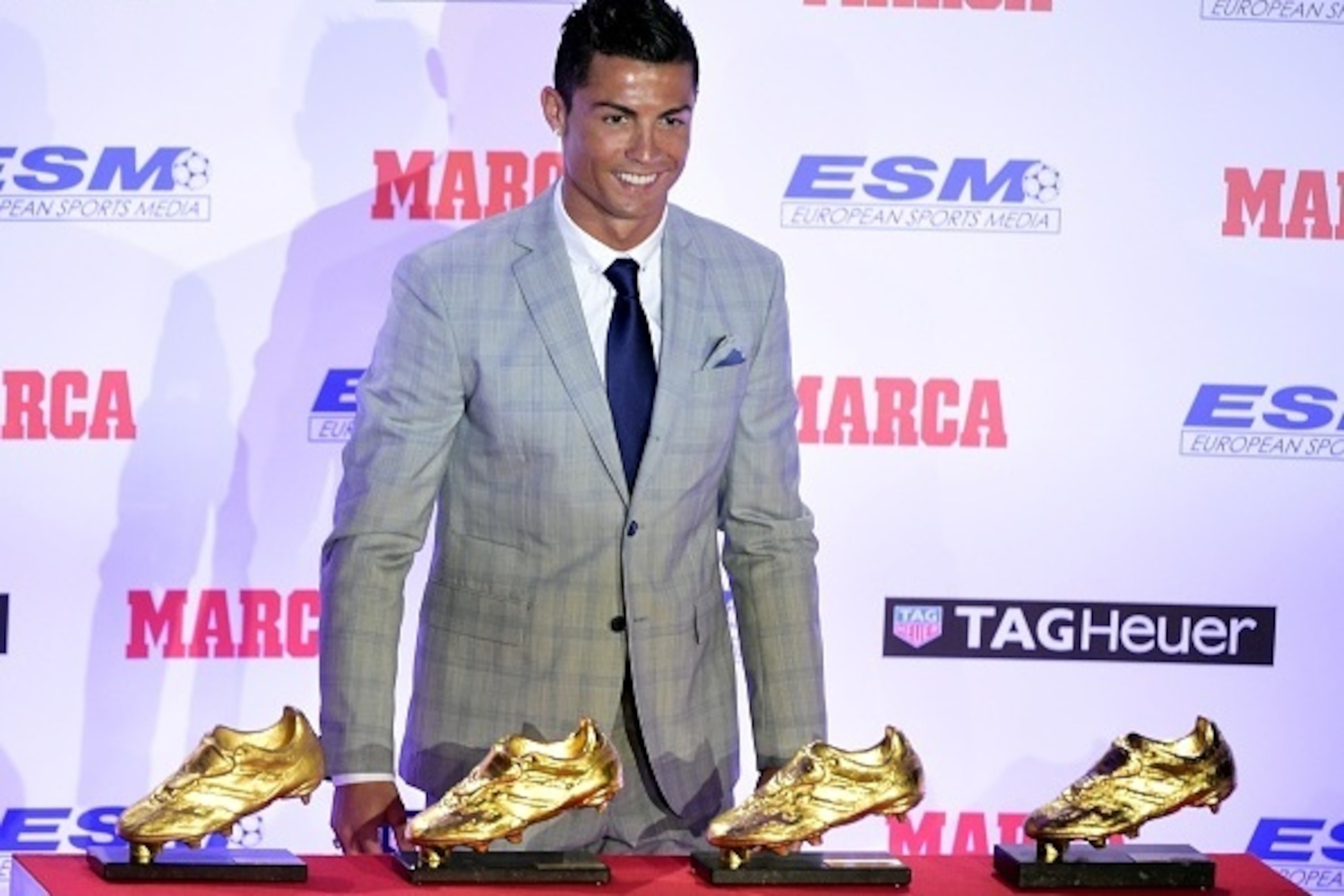 Real Madrid's Portuguese forward Cristiano Ronaldo poses with his European Golden Shoes after receiving the fourth one, on October 13, 2015 in Madrid. Cristiano, who ended the season with 48 goals from 35 appearances, won the Golden Shoe in 2008 while he 