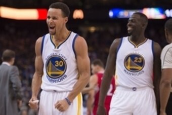 November 4, 2015; Oakland, CA, USA; Golden State Warriors guard Stephen Curry (30) and forward Draymond Green (23) celebrate during the fourth quarter against the Los Angeles Clippers at Oracle Arena. The Warriors defeated the Clippers 112-108. Mandatory 