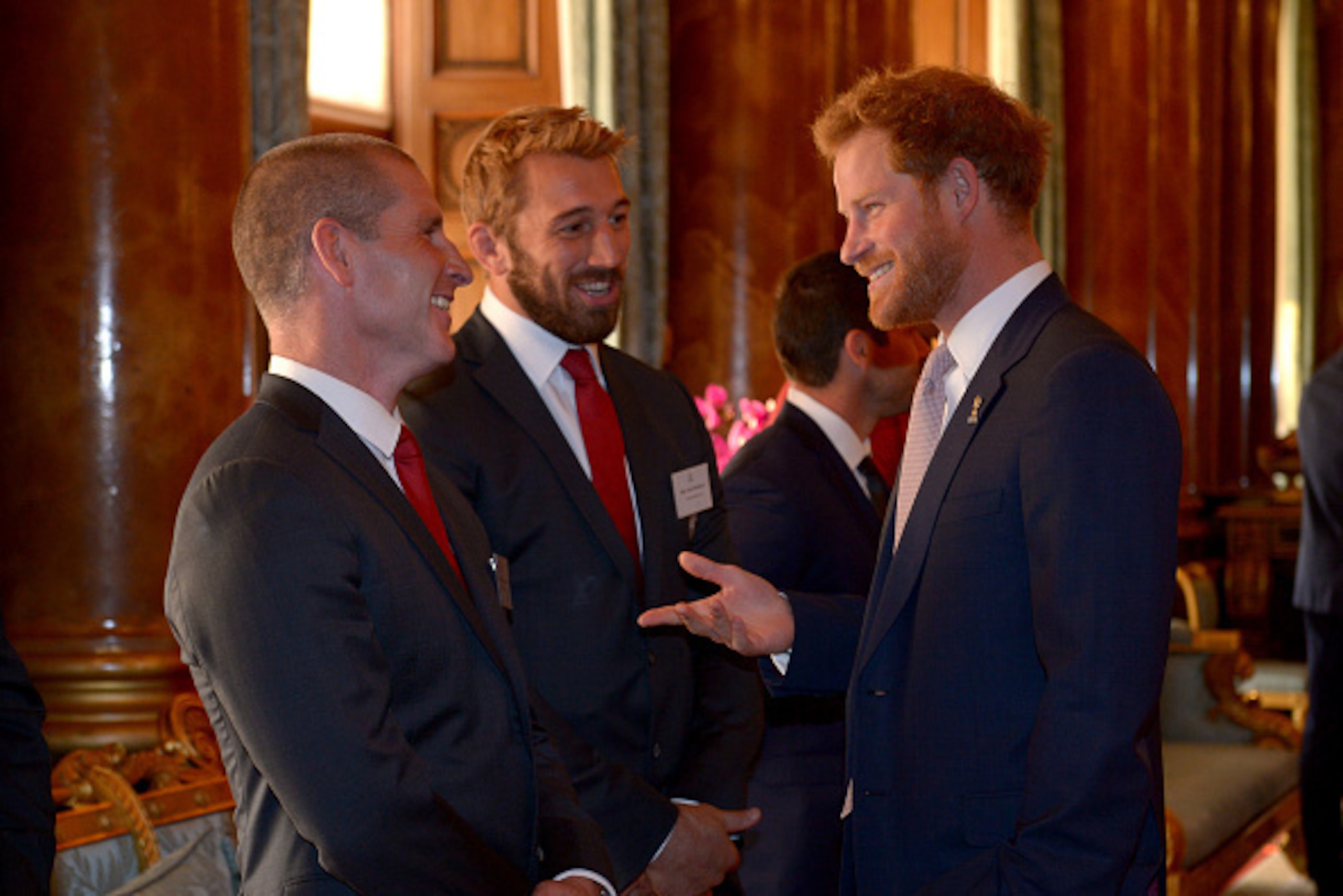 LONDON, UNITED KINGDOM - OCTOBER 12:  Prince Harry speaks with England Rugby Union head coach Stuart Lancaster (left) and England captain Chris Robshaw (second left) during a reception to mark the Rugby World Cup 2015 at Buckingham Palace on October 12, 2