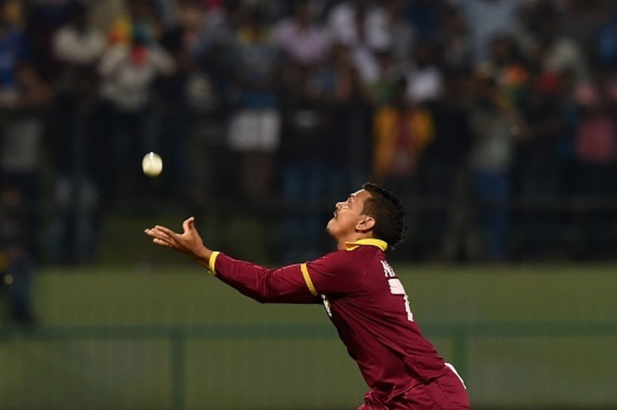 West Indies cricketer Sunil Narine takes a catch to dismiss Sri Lankan cricketer Shehan Jayasuriya during the first Twenty20 International cricket match between Sri Lanka and the West Indies at the Pallekele International Cricket Stadium in Pallekele on N