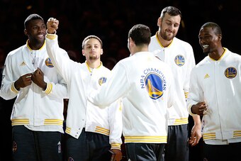OAKLAND, CA - OCTOBER 27:  Festus Ezeli #31, Stephen Curry #30, Klay Thompson #11, Andrew Bogut #12 and Harrison Barnes #40 of the Golden State Warriors celebrate after receiving their championship rings prior to their game against the New Orleans Pelican