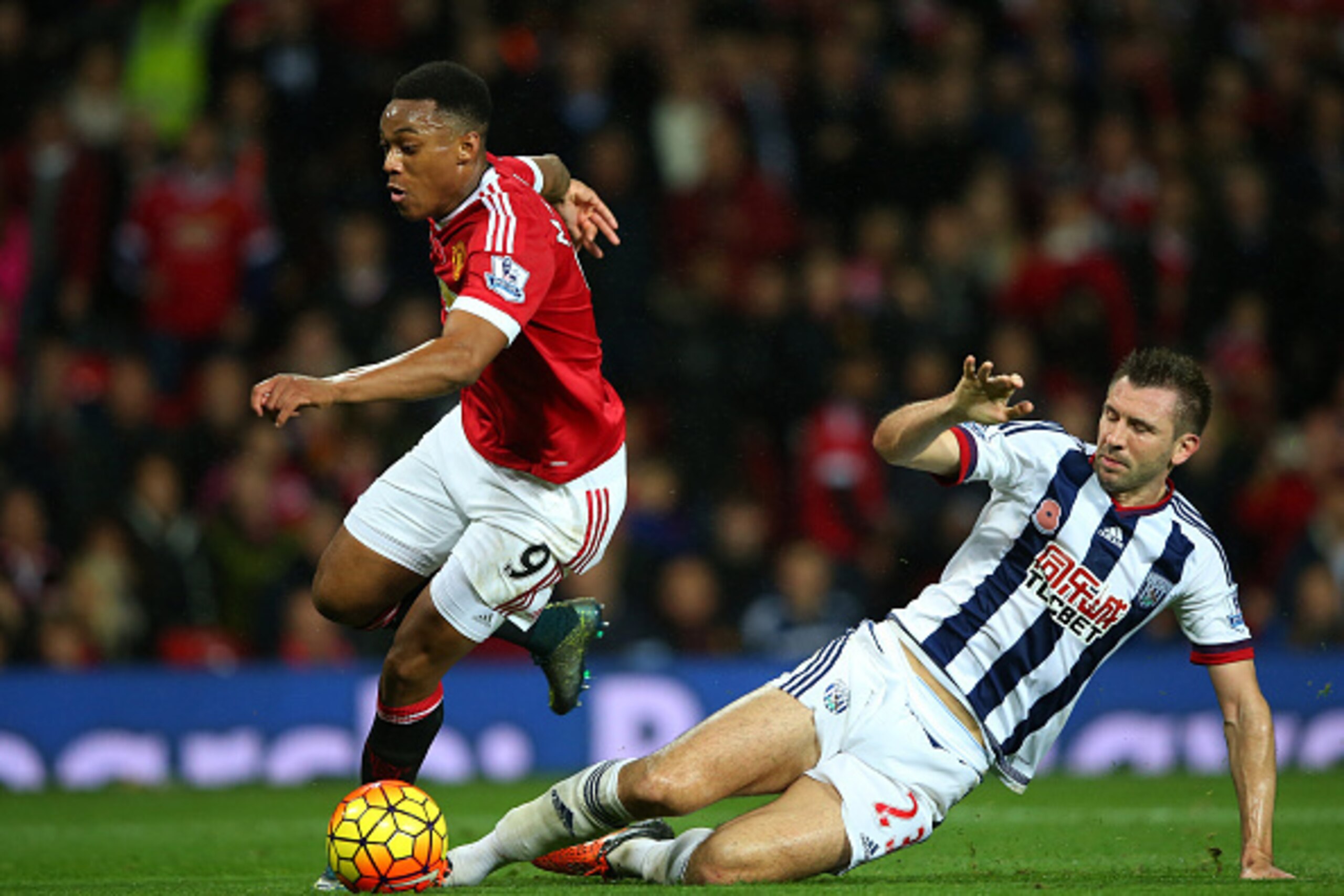 MANCHESTER, ENGLAND - NOVEMBER 07: Anthony Martial of Manchester United is fouled by Gareth McAuley of West Bromwich Albion in the penalty area resulting in the Manchester United's second goal during the Barclays Premier League match between Manchester Un