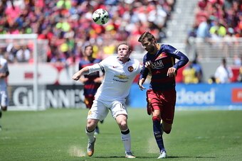 SANTA CLARA, CA - JULY 25:   Wayne Rooney of Manchester United and Gerard Pique of FC Barcelona battle for the ball during the International Champions Cup 2015 match between Manchester United and FC Barcelona at Levi's Stadium on July 25, 2015 in Santa Cl