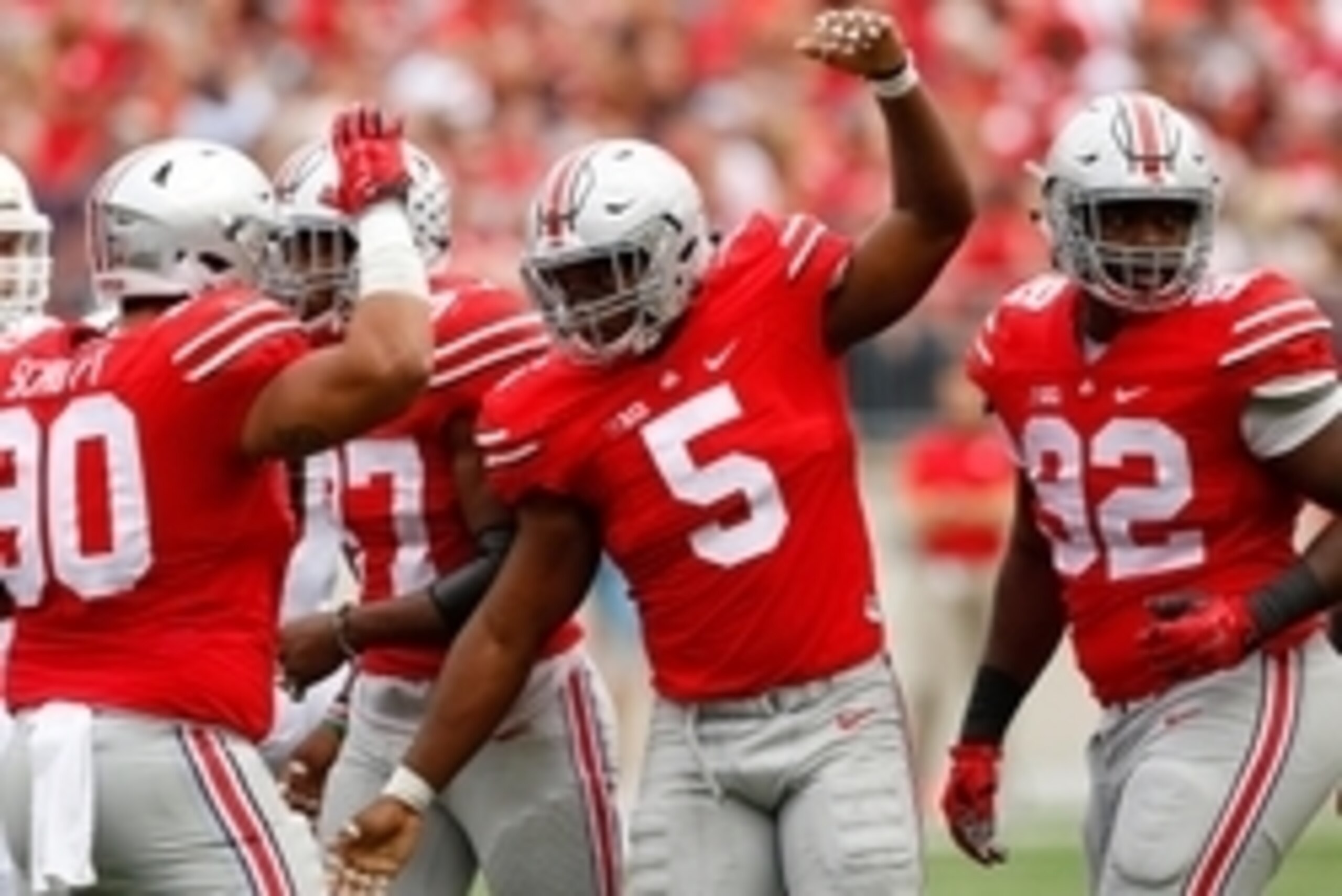 Sep 26, 2015; Columbus, OH, USA; Ohio State Buckeyes linebacker Raekwon McMillan (5) celebrates his first quarter sack with teammate Tommy Schutt (90) versus the Western Michigan Broncos at Ohio Stadium. Ohio State won the game 38-12. Mandatory Credit: Jo