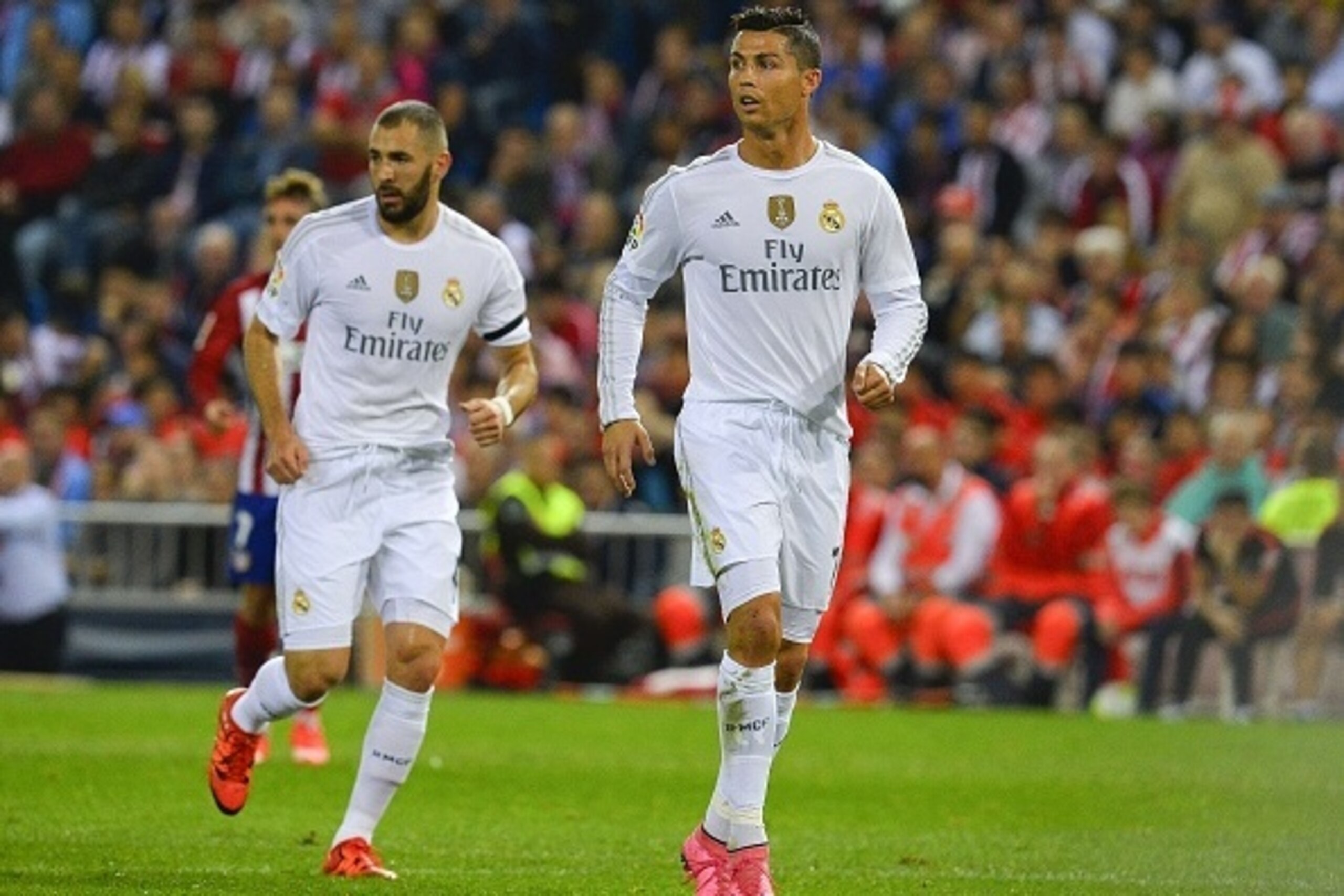 Real Madrid's French forward Karim Benzema (L) and Real Madrid's Portuguese forward Cristiano Ronaldo look on during the Spanish league football match Club Atletico de Madrid vs Real Madrid CF at the Vicente Calderon stadium in Madrid on October 4, 2015. 