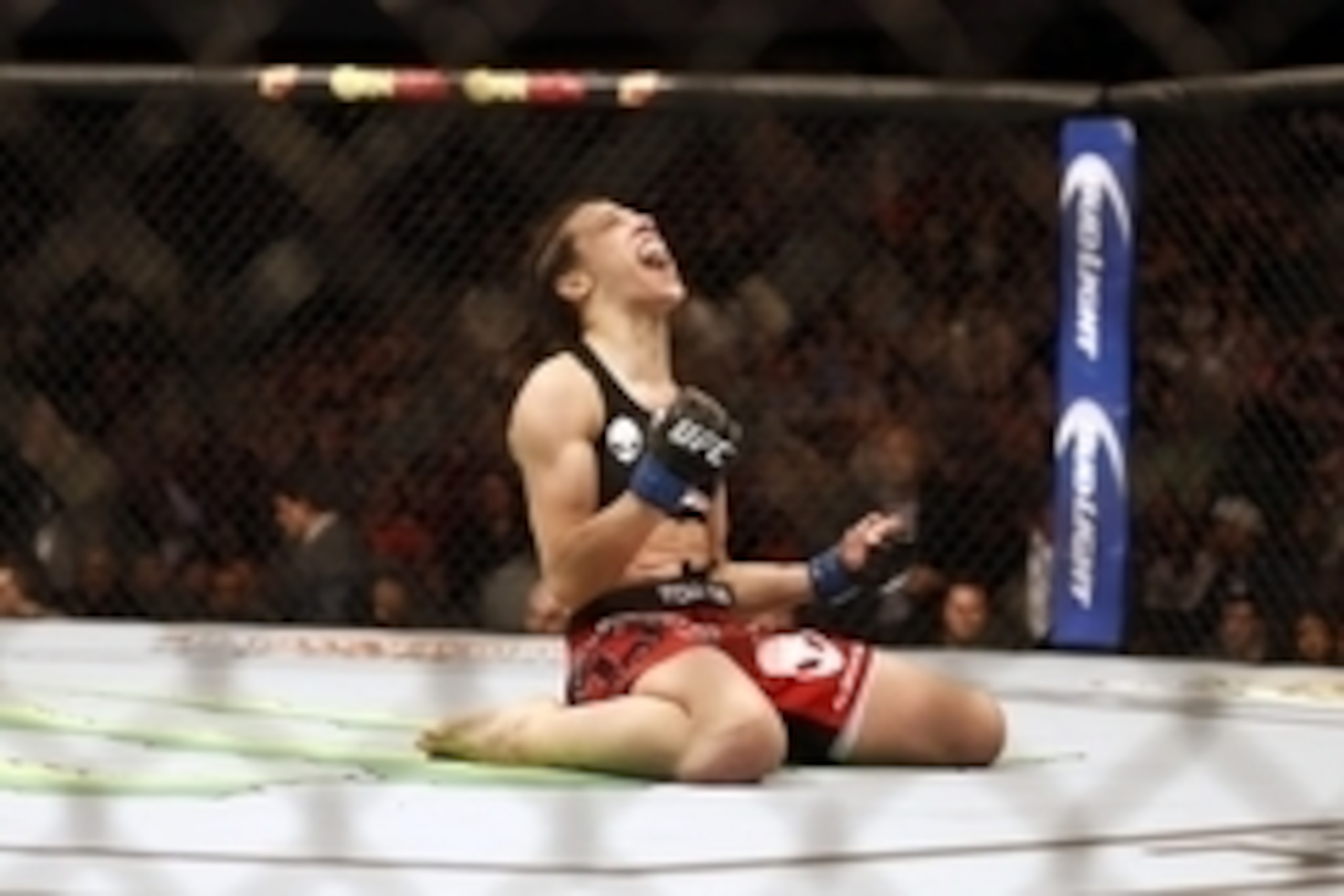 Mar 14, 2015; Dallas, TX, USA;  Joanna Jedrzejczyk (blue) celebrates defeating Carla Esparza (red) in the women's strawweight title bout during UFC 185 at American Airlines Center. Mandatory Credit: Tim Heitman-USA TODAY Sports