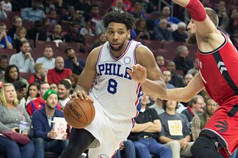 PHILADELPHIA, PA - NOVEMBER 11: Jahlil Okafor #8 of the Philadelphia 76ers drives as Jonas Valanciunas #17 of the Toronto Raptors defends him on the play on November 11, 2015 at the Wells Fargo Center in Philadelphia, Pennsylvania. NOTE TO USER: User expr
