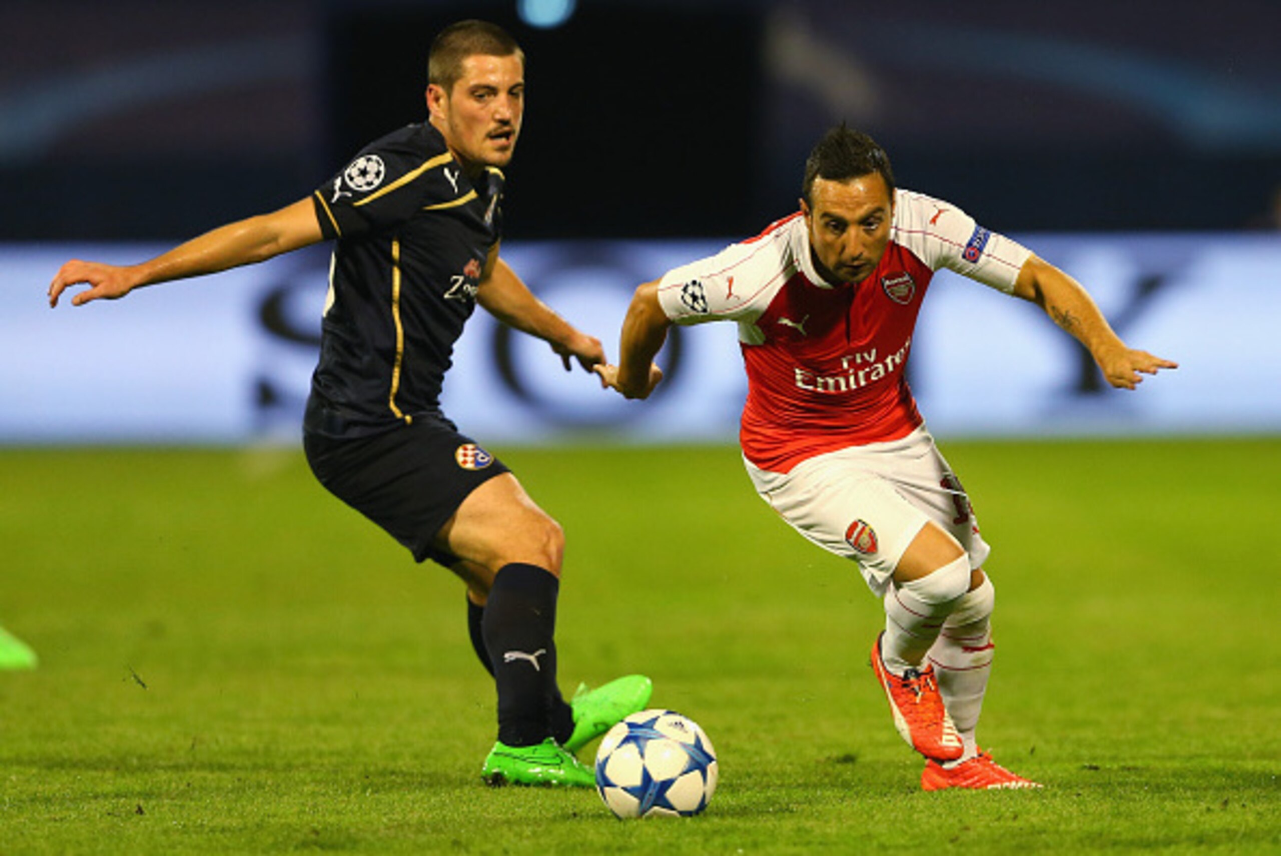 ZAGREB, CROATIA - SEPTEMBER 16:  Santi Cazorla of Arsenal goes past Arijan Ademi of Dinamo Zagreb during the UEFA Champions League Group F match between Dinamo Zagreb and Arsenal at Maksimir Stadium on September 16, 2015 in Zagreb, Croatia.  (Photo by Ale