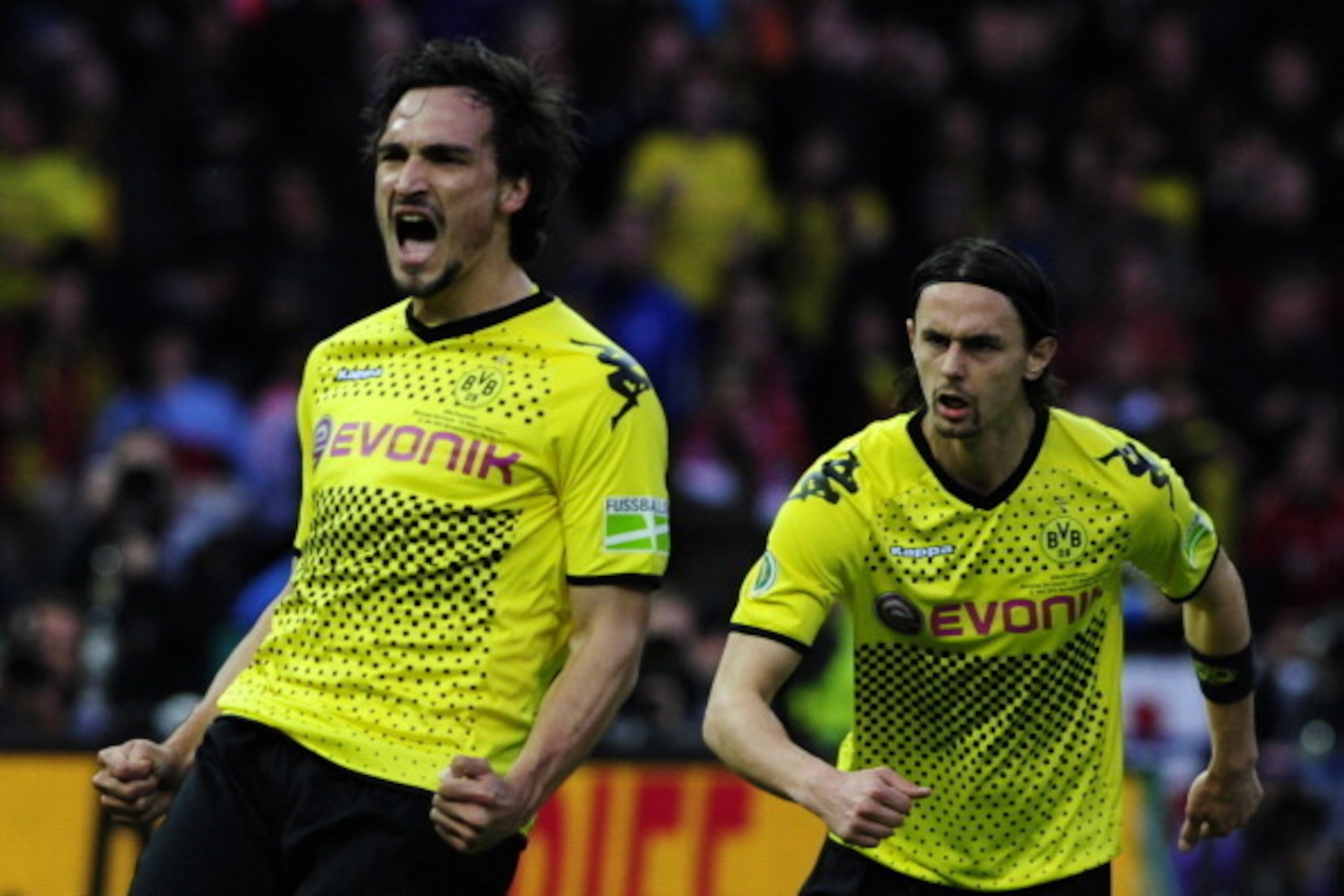 Dortmund's defender Mats Hummels (L) celebrates with his teammate Dortmund's US defender Neven Subotic after scoring the 2-1 during the German cup ' DFB Pokal ' final football match Borussia Dortmund vs Bayern Munich at the Olympiastadion in Berlin on May