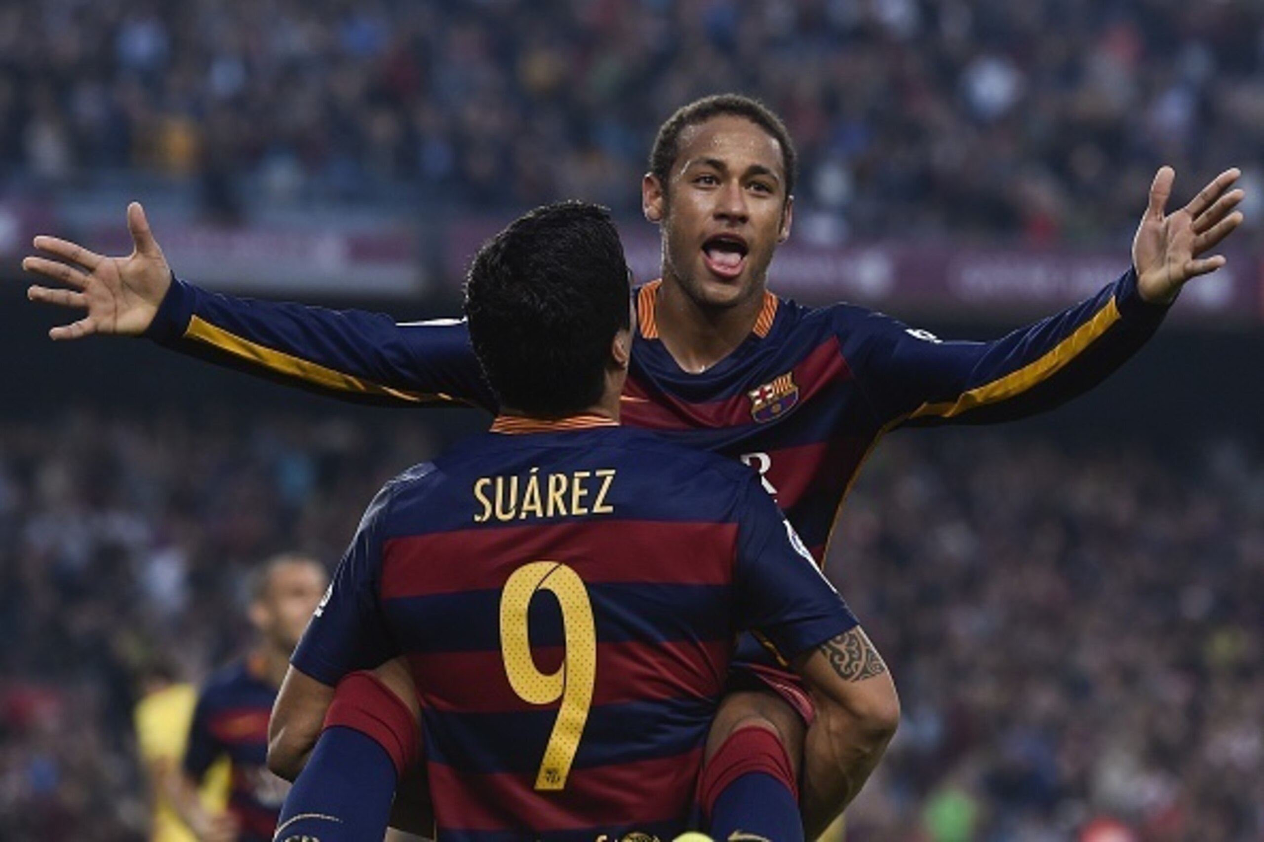 Barcelona's Brazilian forward Neymar da Silva Santos Junior (back) is congratulated by his teammate Barcelona's Uruguayan forward Luis Suarez after scoring during the Spanish league football match FC Barcelona vs Villarreal CF at the Camp Nou stadium in B