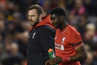 Liverpool's Ivorian defender Kolo Toure (R) is escorted off the putch injured during the English League Cup fourth round football match between Liverpool and Bournemouth at Anfield stadium in Liverpool, north west England on October 28, 2015. AFP PHOTO / 