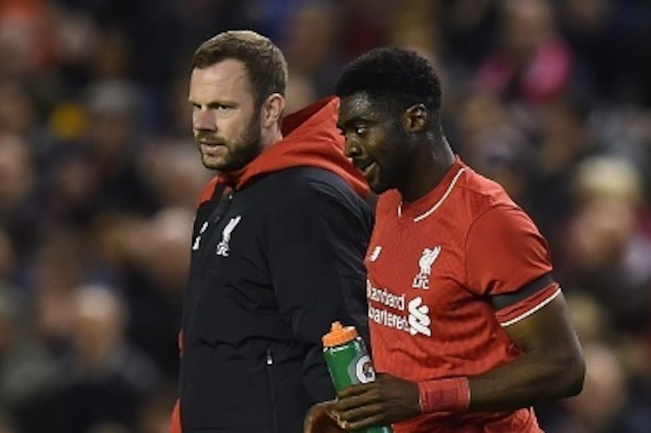 Liverpool's Ivorian defender Kolo Toure (R) is escorted off the putch injured during the English League Cup fourth round football match between Liverpool and Bournemouth at Anfield stadium in Liverpool, north west England on October 28, 2015. AFP PHOTO / 