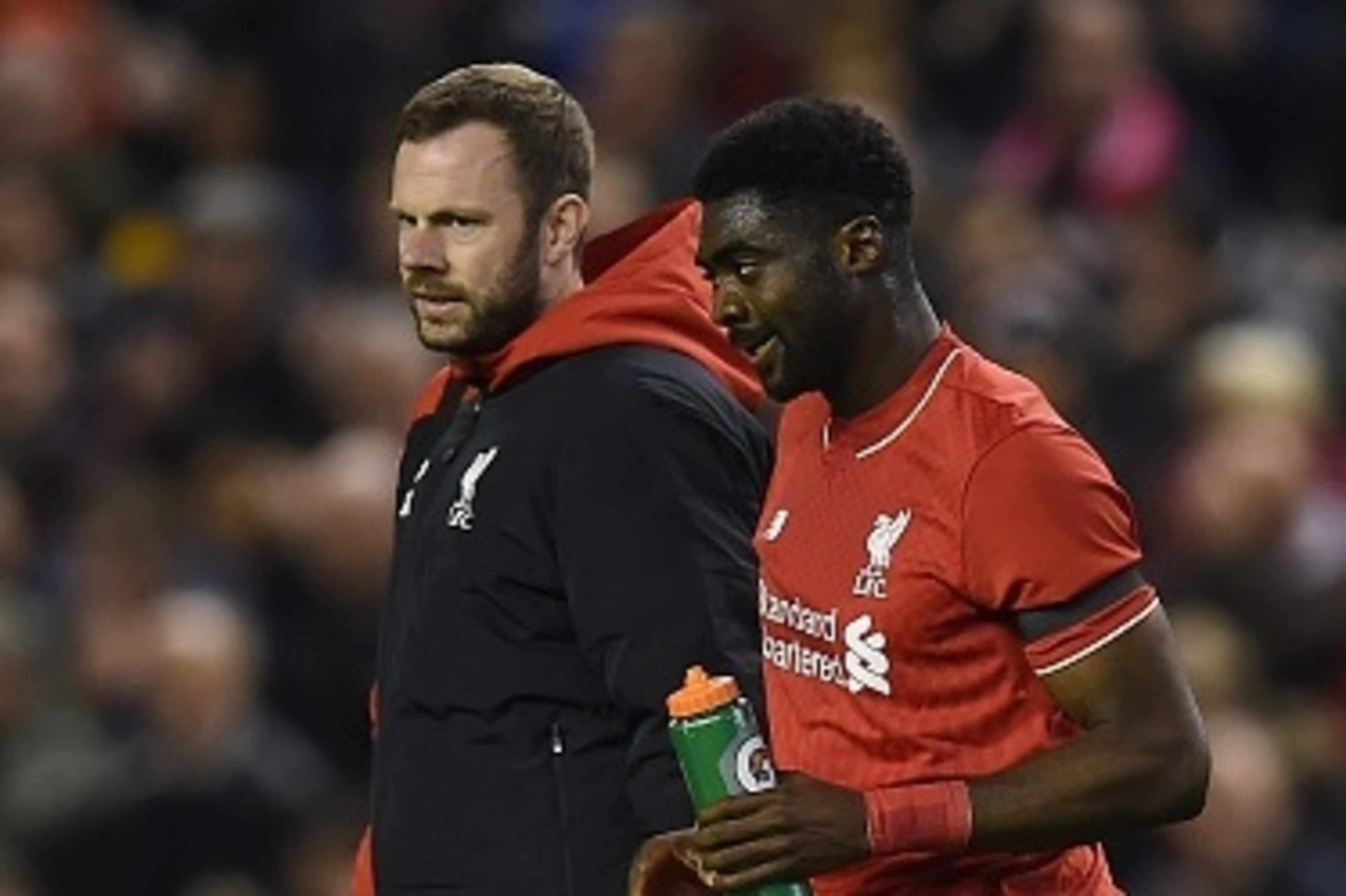 Liverpool's Ivorian defender Kolo Toure (R) is escorted off the putch injured during the English League Cup fourth round football match between Liverpool and Bournemouth at Anfield stadium in Liverpool, north west England on October 28, 2015. AFP PHOTO / 