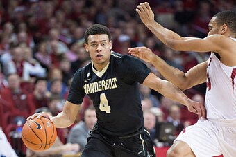 FAYETTEVILLE, AR - JANUARY 10: Wade Baldwin IV #4 of the Vanderbilt Commodores drives around Jabril Durham #4 of the Arkansas Razorbacks at Bud Walton Arena on January 10, 2015 in Fayetteville, Arkansas. The Razorbacks defeated the Commodores 82-70. (Phot