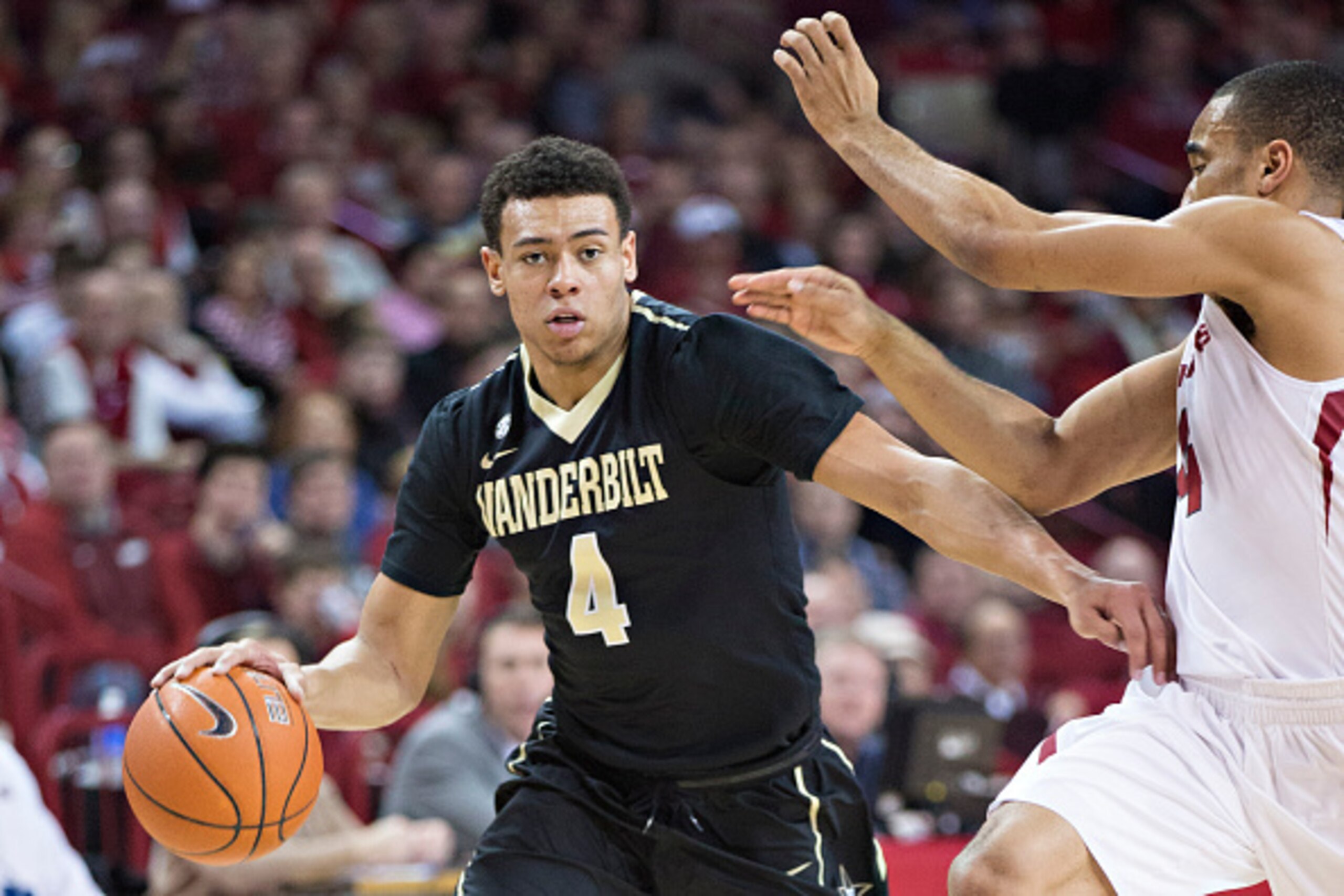 FAYETTEVILLE, AR - JANUARY 10: Wade Baldwin IV #4 of the Vanderbilt Commodores drives around Jabril Durham #4 of the Arkansas Razorbacks at Bud Walton Arena on January 10, 2015 in Fayetteville, Arkansas. The Razorbacks defeated the Commodores 82-70. (Phot