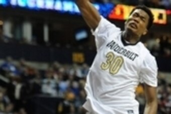 Mar 12, 2015; Nashville, TN, USA; Vanderbilt Commodores center Damian Jones (30) dunks the ball over Tennessee Volunteers guard Devon Baulkman (34) during the first half of the second round of the SEC Conference Tournament at Bridgestone Arena. Mandatory 