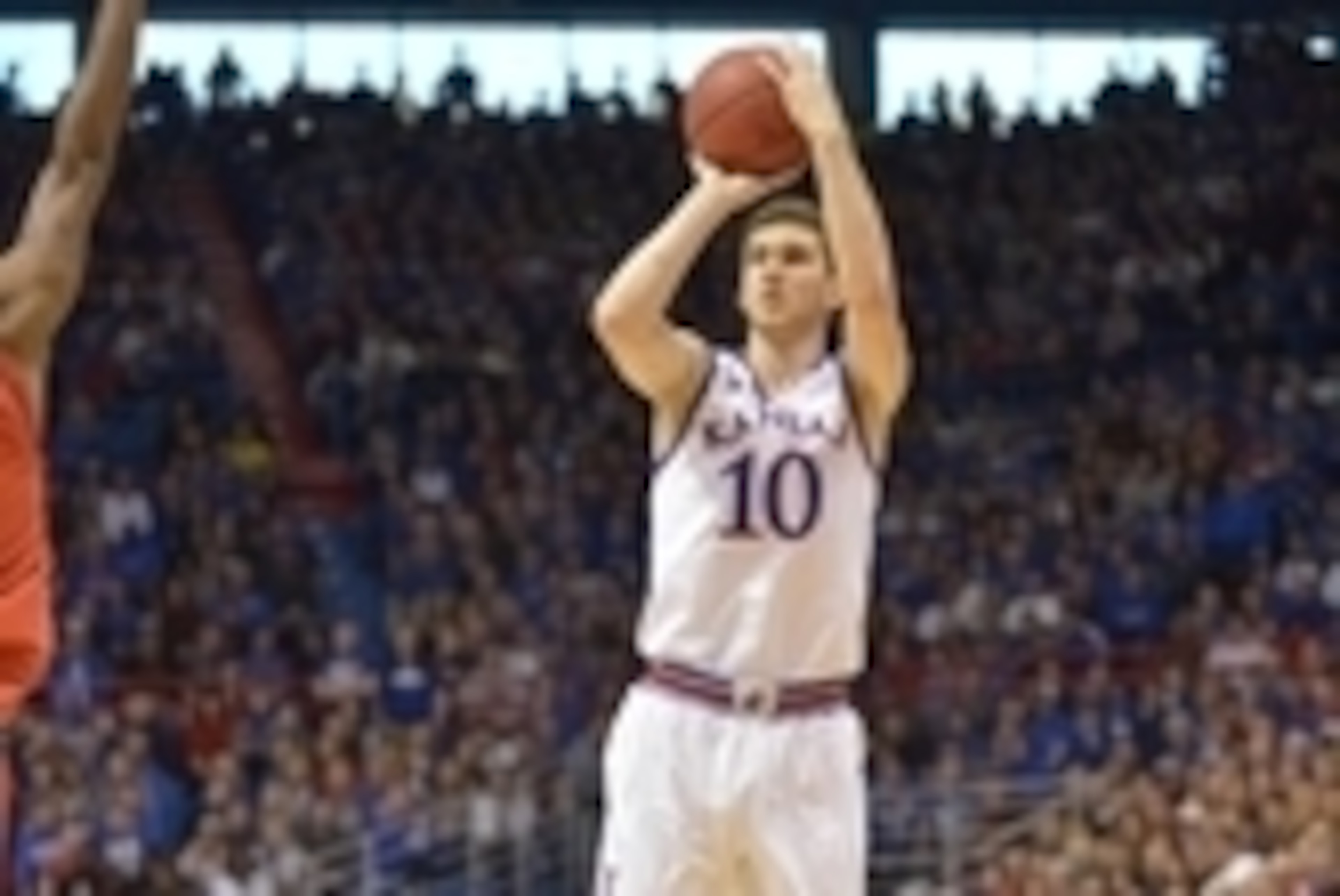 Jan 10, 2015; Lawrence, KS, USA; Kansas Jayhawks guard Sviatoslav Mykhailiuk (10) shoots the ball as Texas Tech Red Raiders guard Keenan Evans (12) defends during the second half at Allen Fieldhouse. Kansas won 86-54. Mandatory Credit: Denny Medley-USA TO