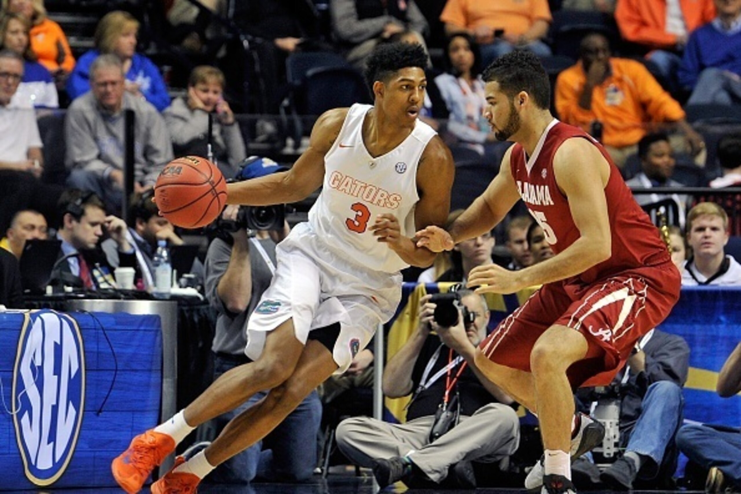 NASHVILLE, TN - MARCH 12:  Devin Robinson #3 of the Florida Gators dribbles into Dakota Slaughter #35 of the Alabama Crimson Tide during a second round game of the SEC Basketball Tournament at Bridgestone Arena on March 12, 2015 in Nashville, Tennessee.  