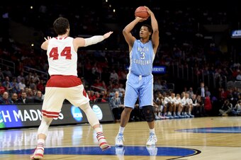 LOS ANGELES, CA - MARCH 26:  Kennedy Meeks #3 of the North Carolina Tar Heels shoots over Frank Kaminsky #44 of the Wisconsin Badgers in the first half during the West Regional Semifinal of the 2015 NCAA Men's Basketball Tournament at Staples Center on Ma