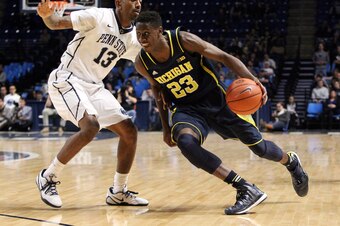 Jan 6, 2015; University Park, PA, USA; Michigan Wolverines guard Caris LeVert (23) dribbles the ball around Penn State Nittany Lions guard Geno Thorpe (13) during the second half at Bryce Jordan Center. Michigan defeated Penn State 73-64. Mandatory Credit