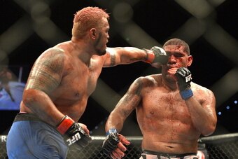 BRISBANE, AUSTRALIA - DECEMBER 07:  Mark Hunt connects with a punch during the UFC Brisbane bout between Mark Hunt and Antonio 'Big Foot' Silva of Brazil at the Brisbane Entertainment Centre on December 7, 2013 in Brisbane, Australia.  (Photo by Bradley K